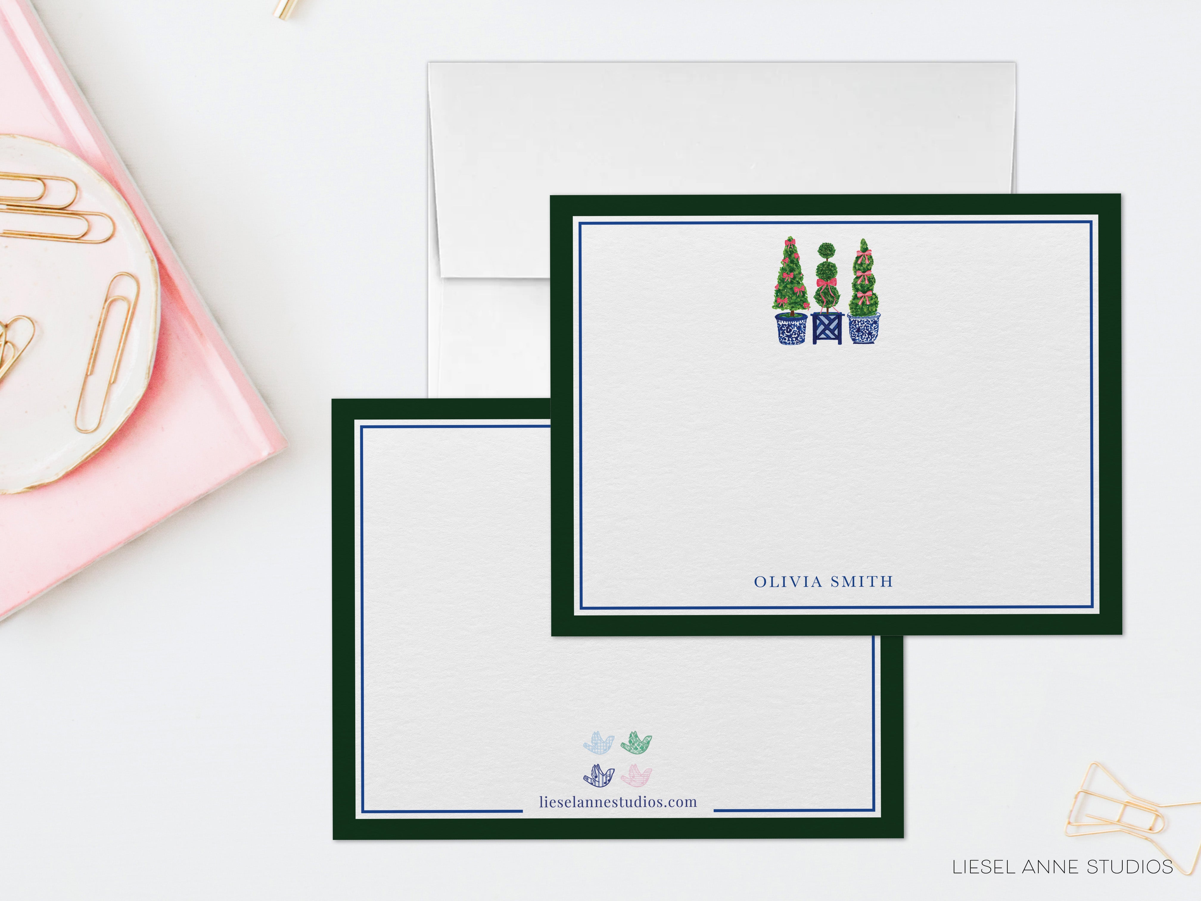 two blank personalized stationery cards with a green border and a white background, each with a unique design and name printed on them.