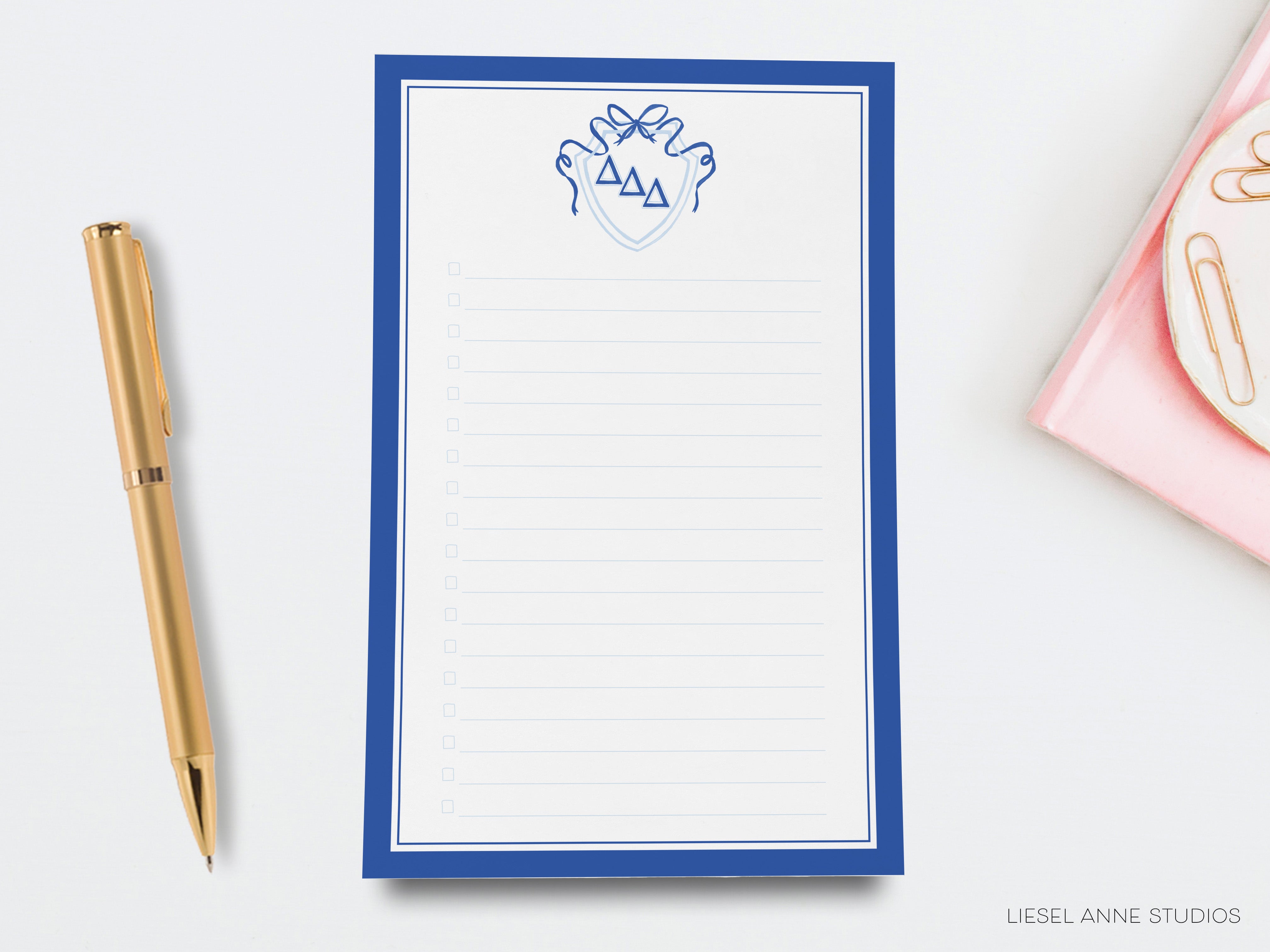 a notepad with a hand drawn crown on it next to a pen