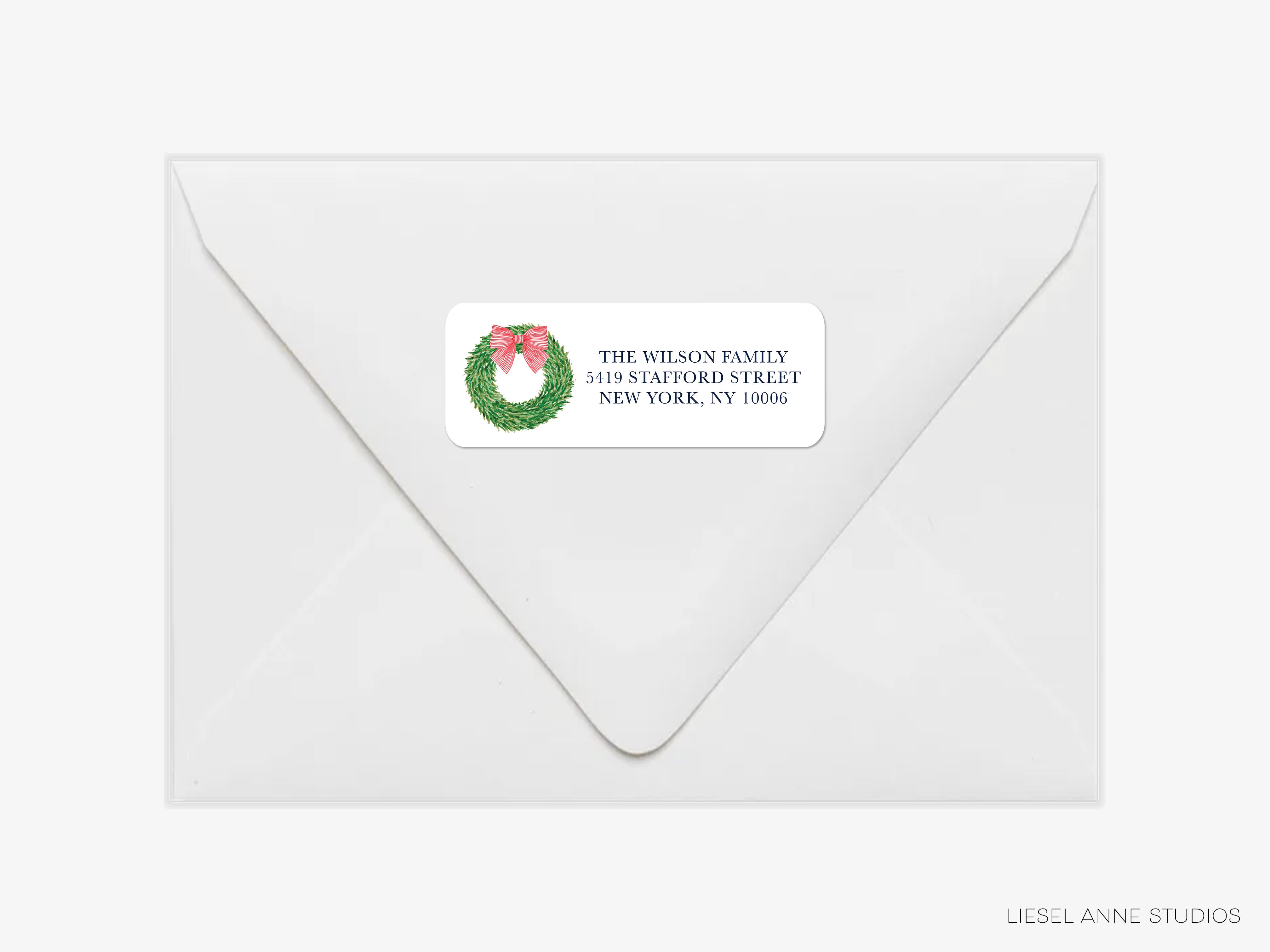 A white envelope with a label on it, featuring a wreath design.
