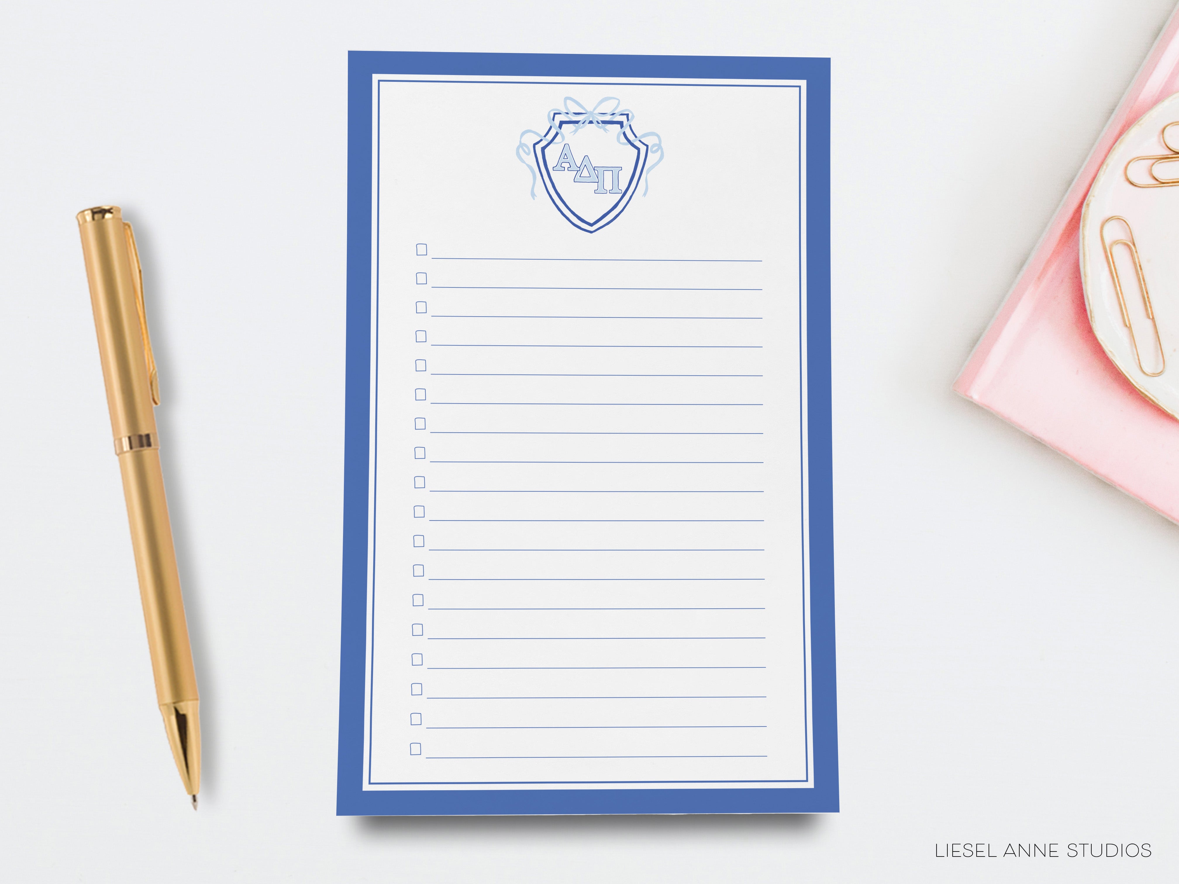 a notepad with a pen next to it on a desk