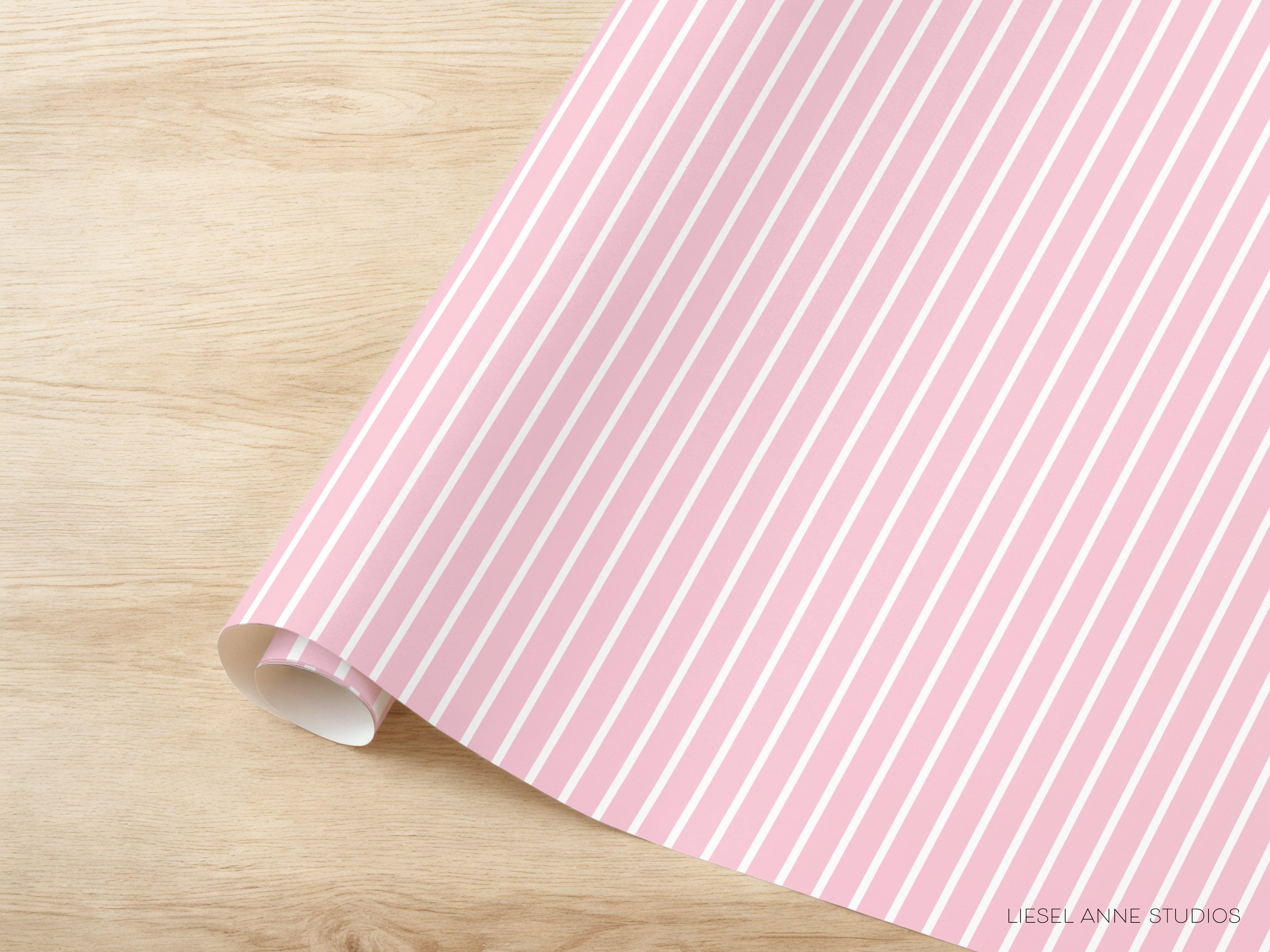 A pink and white striped paper is placed on a wooden surface.