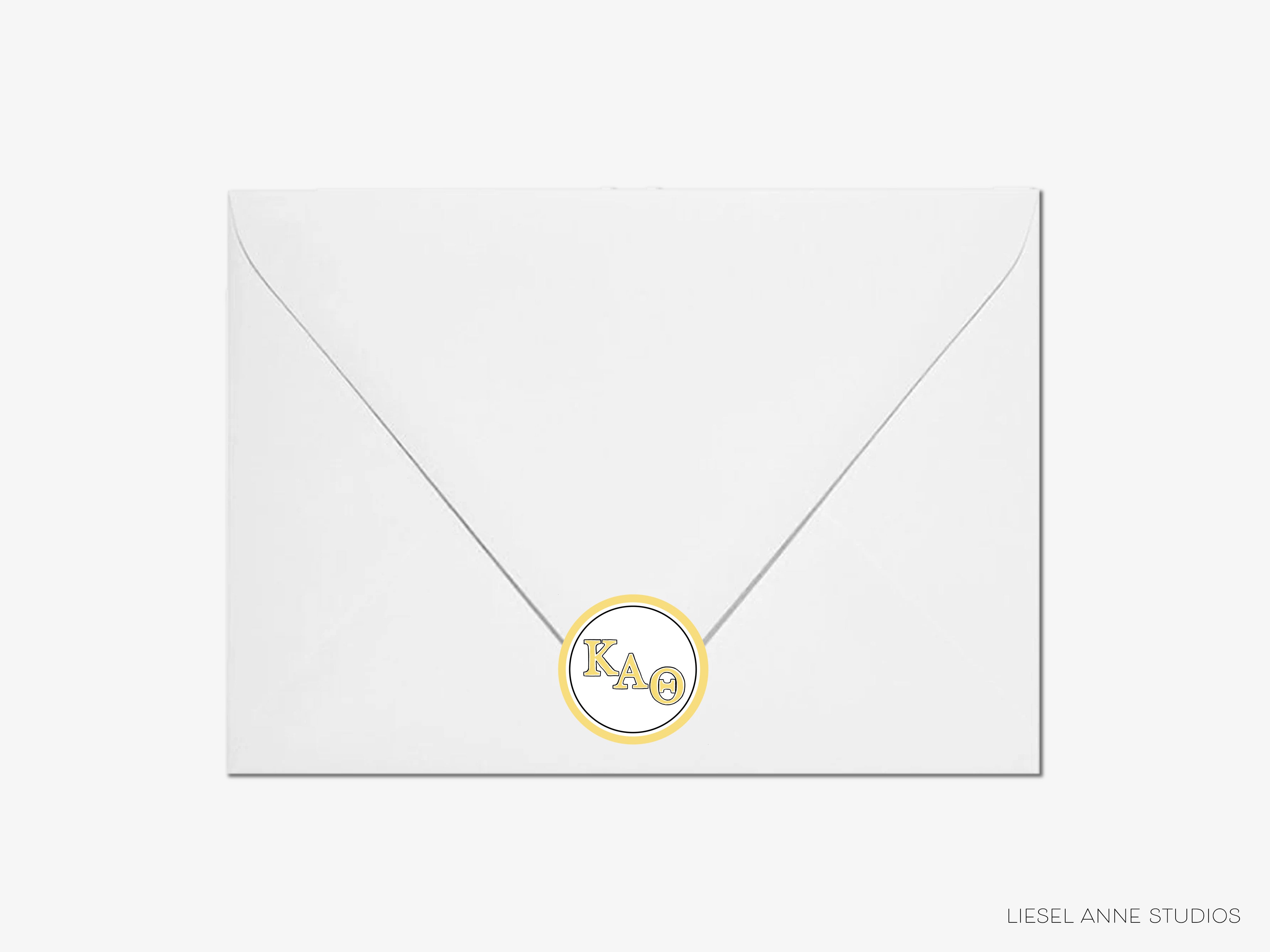 a white envelope with a gold monogrammed circle on it