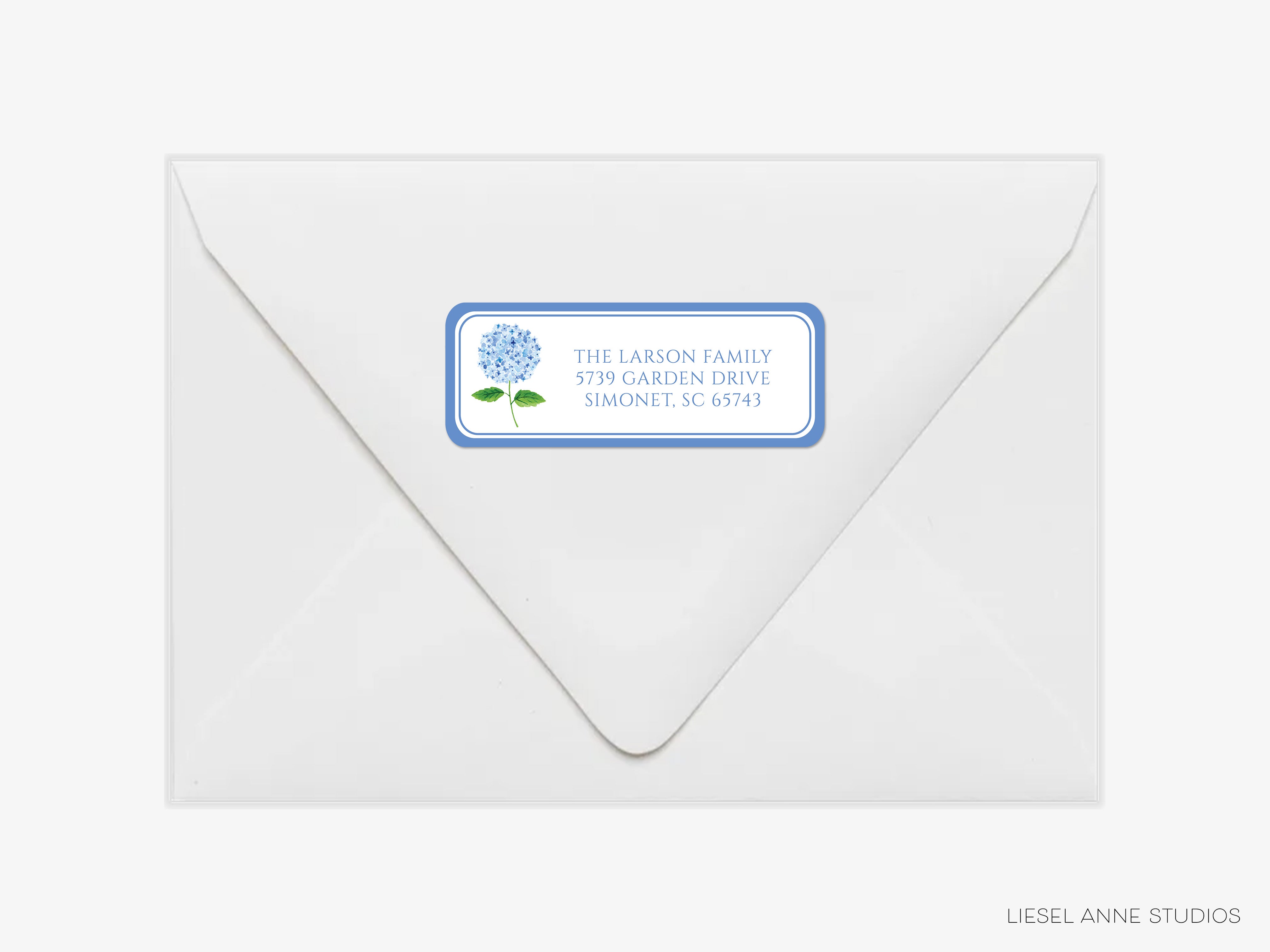 a white envelope with a blue label on it, which contains text and a graphic of a flower.
