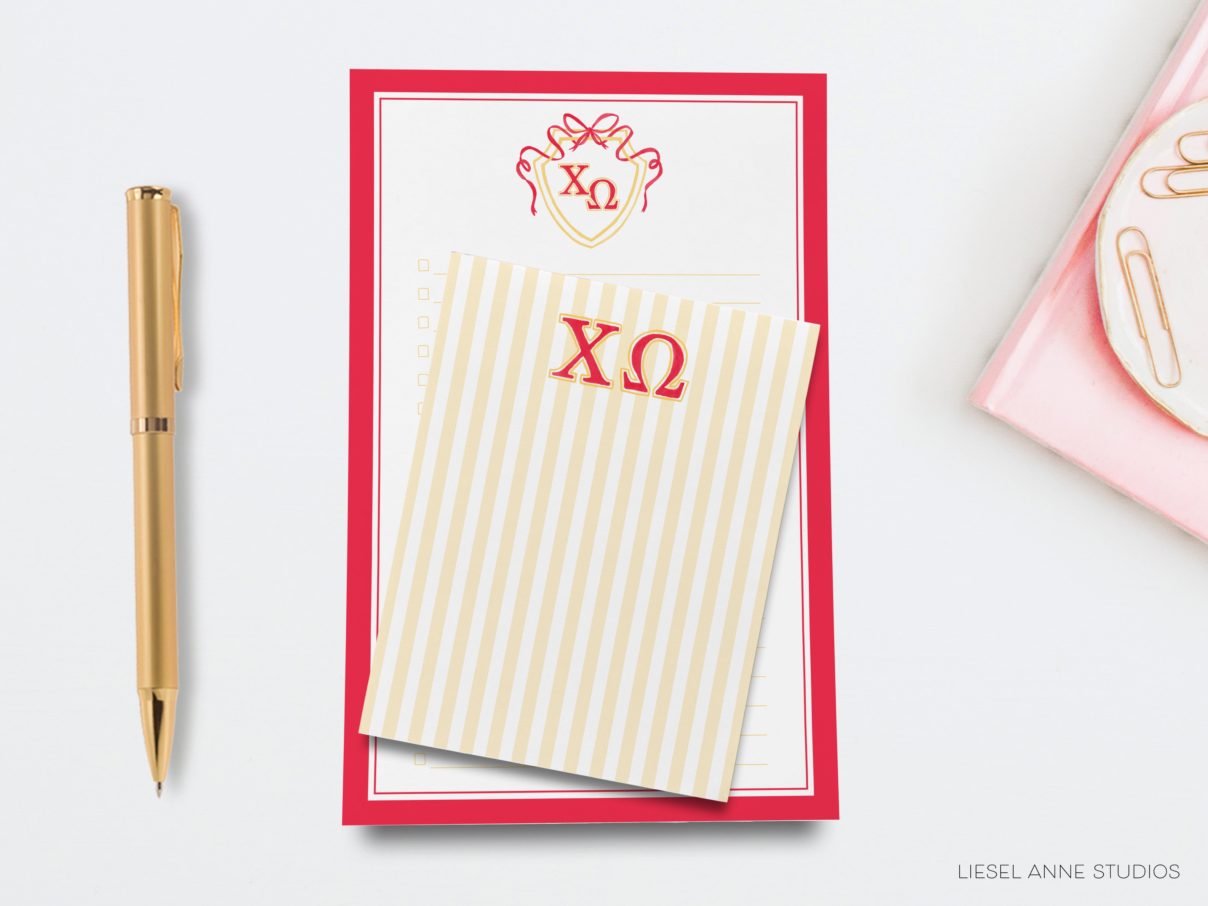 a desk with a notepad, pen, and envelope