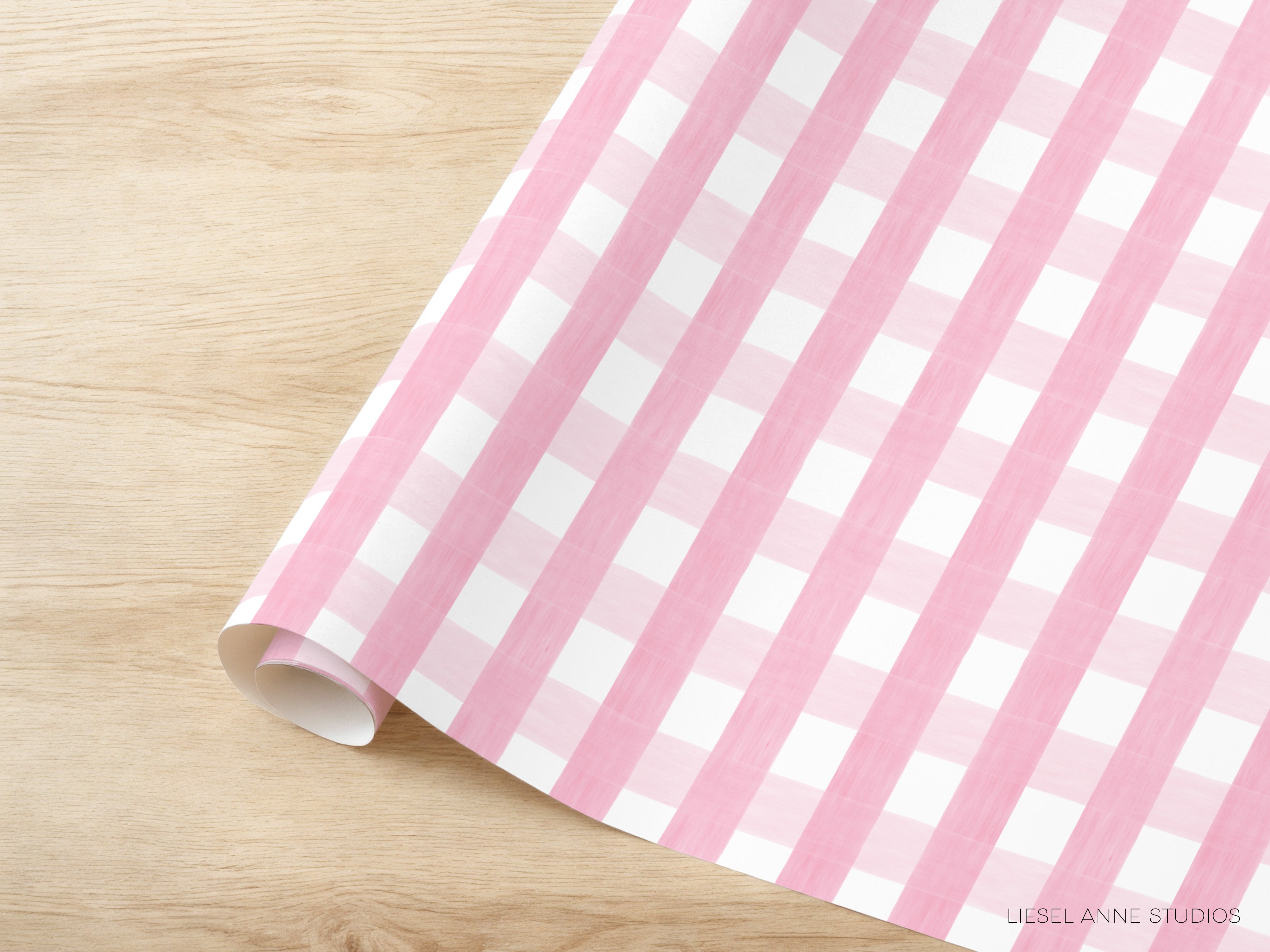 A pink and white checkered pattern is displayed on a wooden surface.