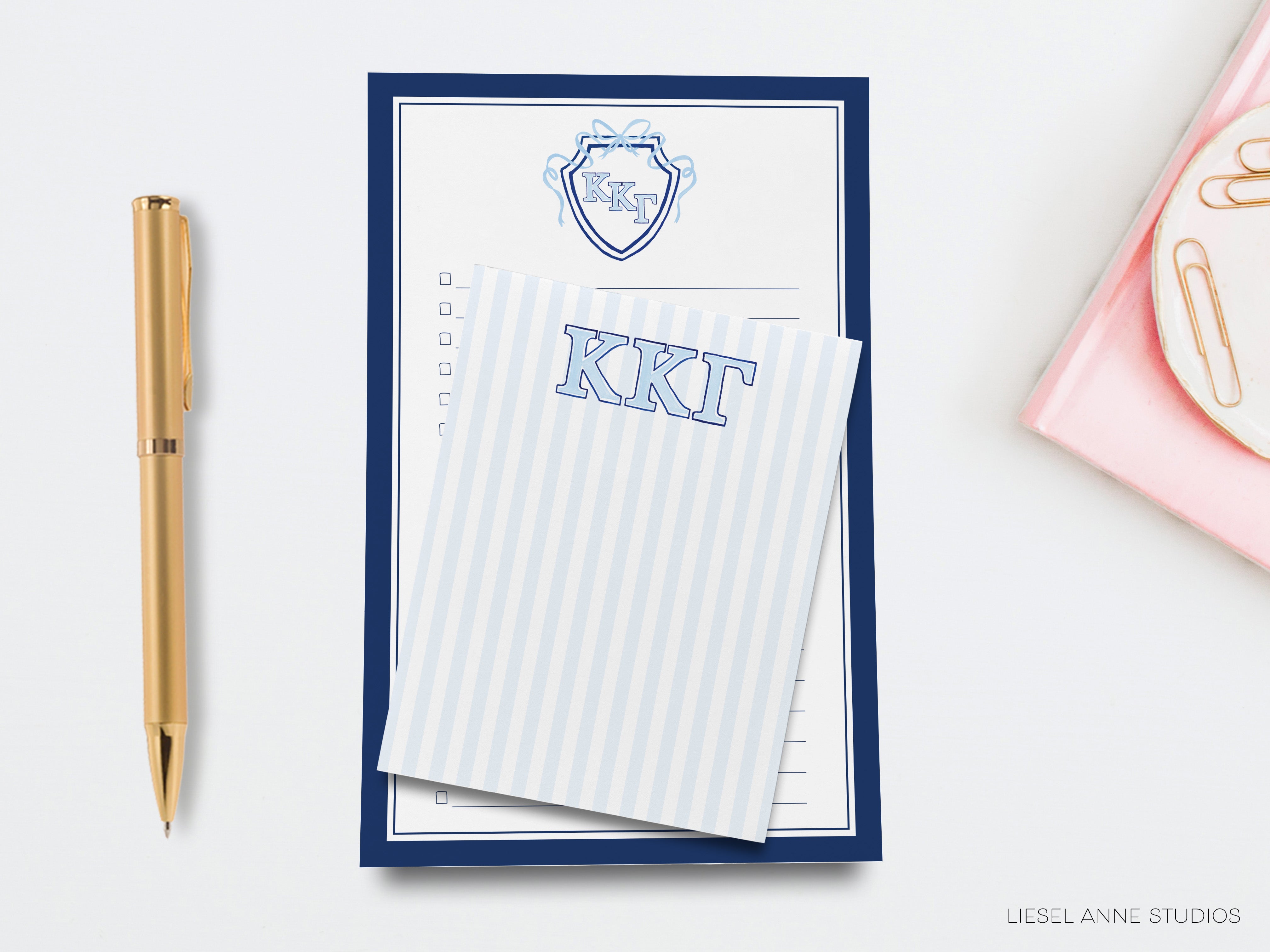 a notepad, pen, and envelope on a desk