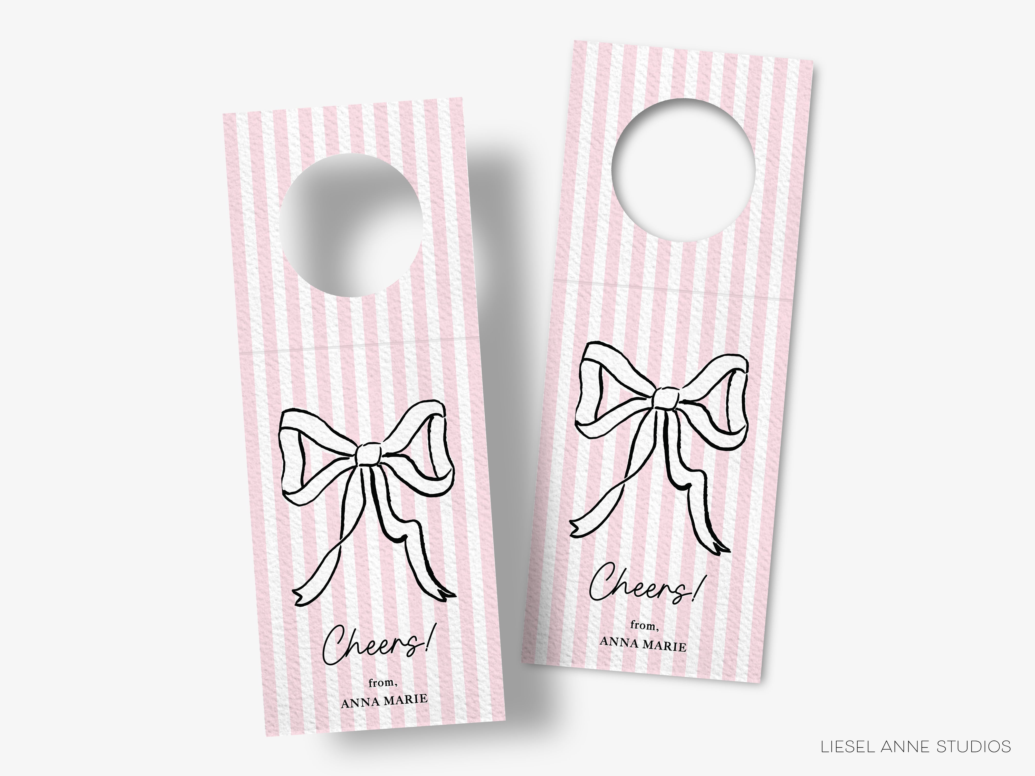 two pink and white striped door tags with a bow design.