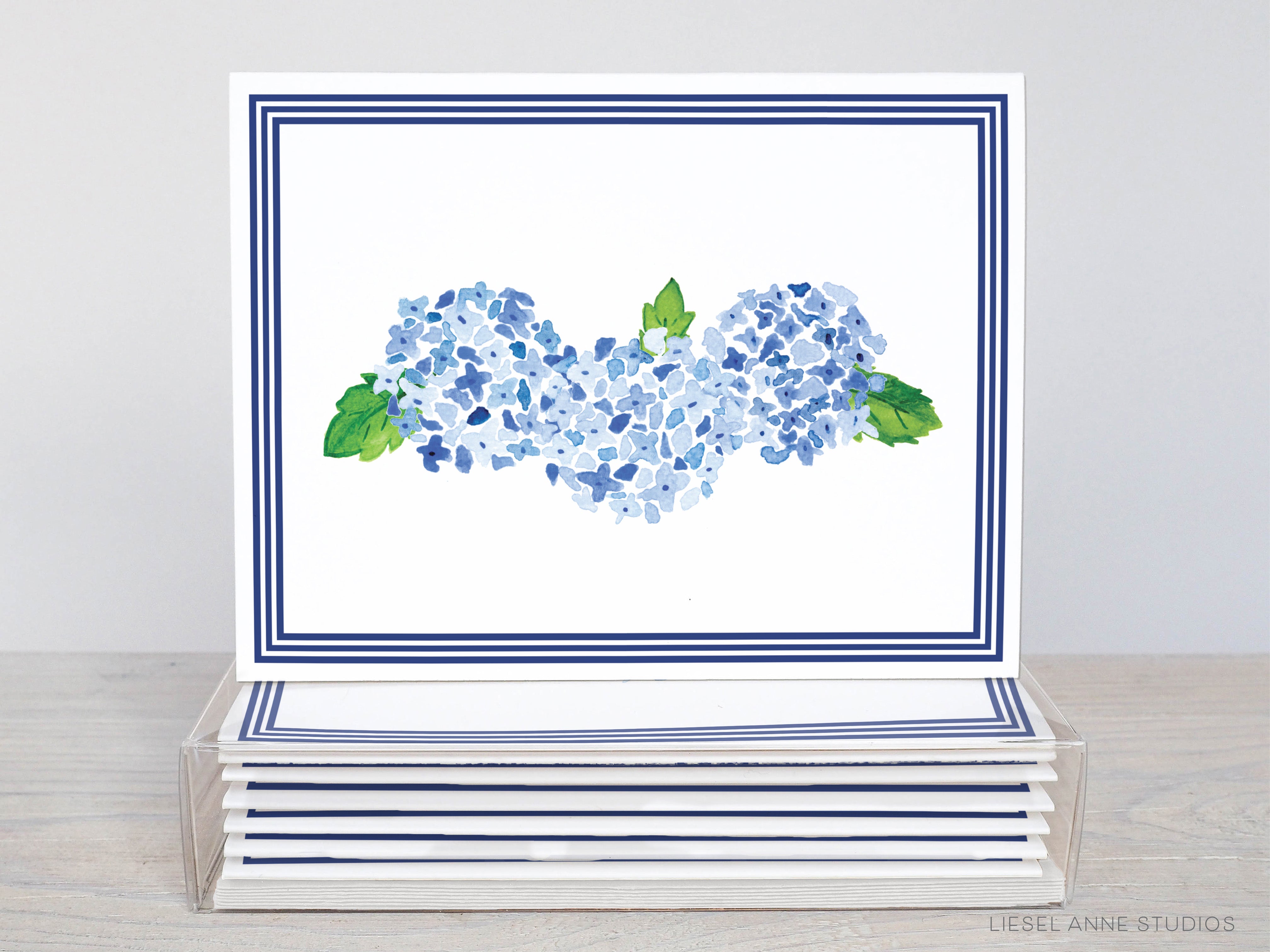 a card with blue flowers and a green leaf