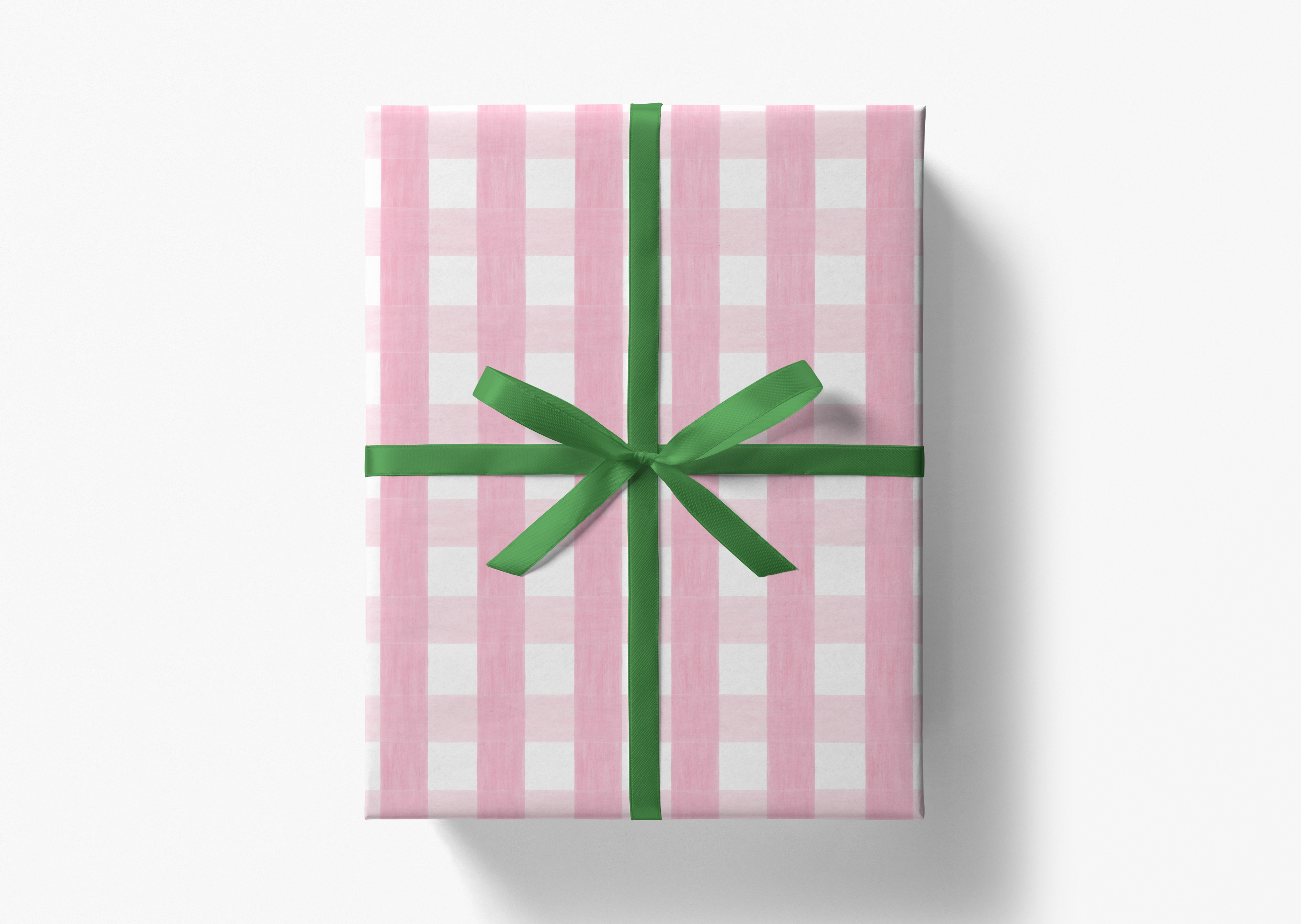 A pink and white checkered gift box with a green ribbon bow tied around it.