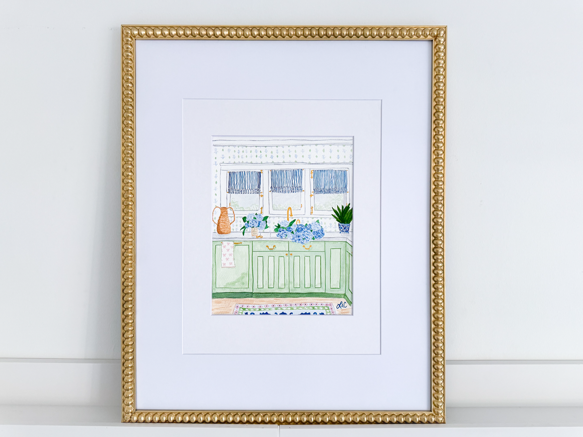 a framed illustration of a kitchen scene with a green cabinet, a sink, and various decorative elements such as a vase and a potted plant.