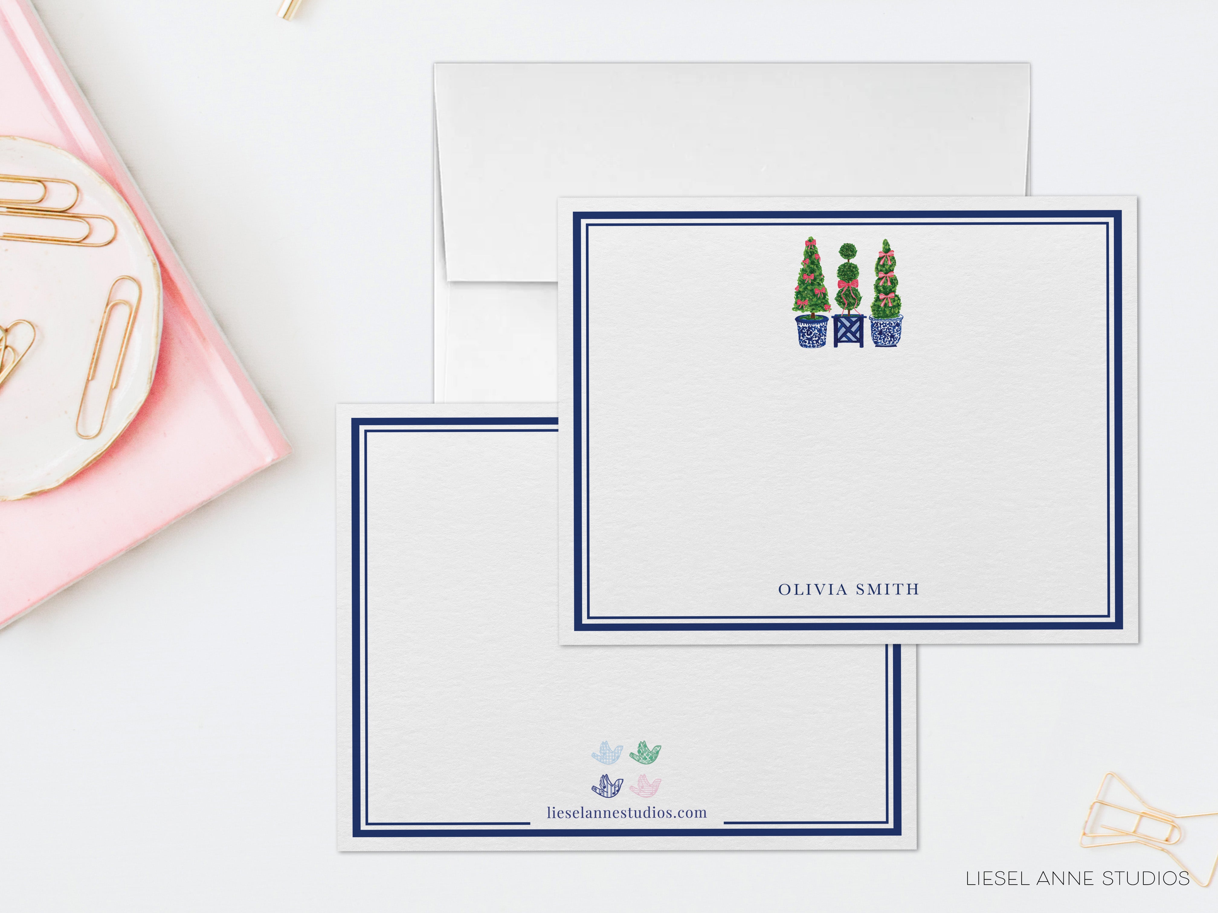 two blank personalized stationery cards with a blue border, each with a unique design and name printed on them.