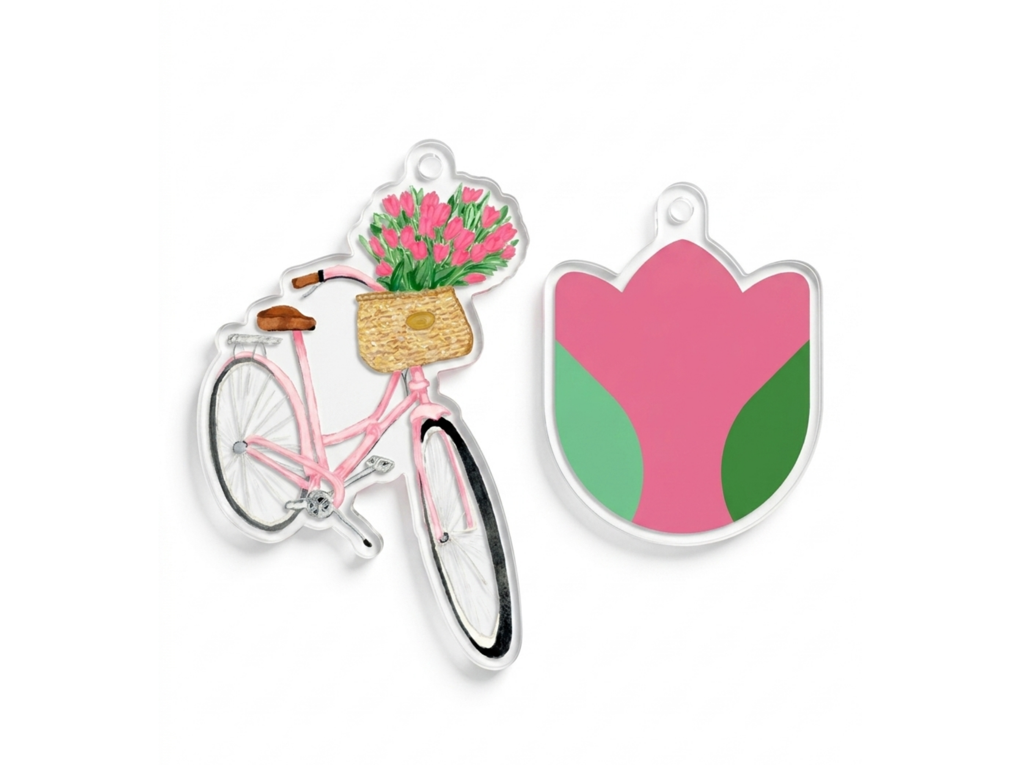 two clear acrylic charms, one depicting a pink bicycle with a basket of pink flowers and the other depicting a pink flower-shaped charm.