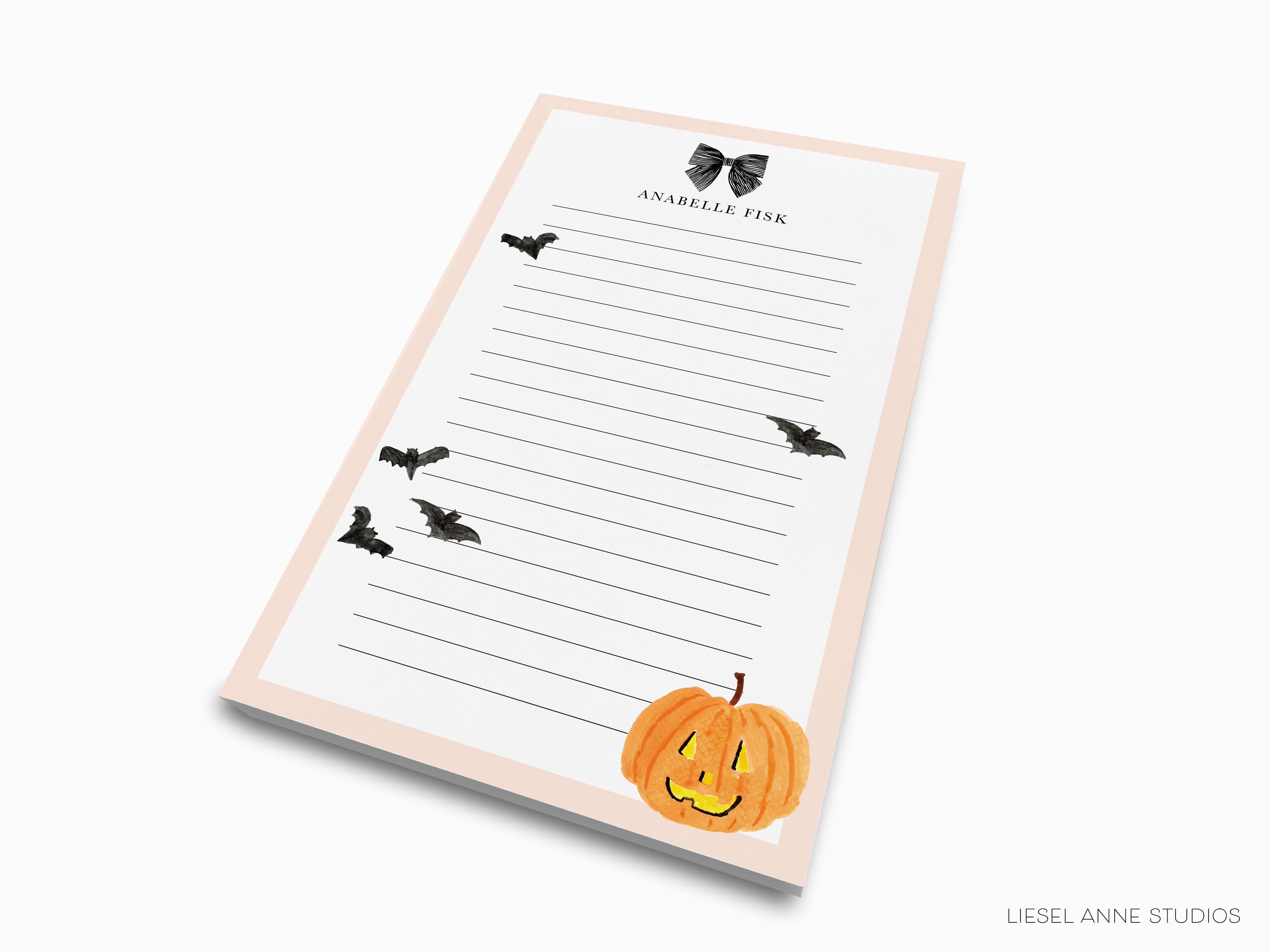 a lined paper pad with a pumpkin and bats design, and the text "ANABEL TIK" at the top.