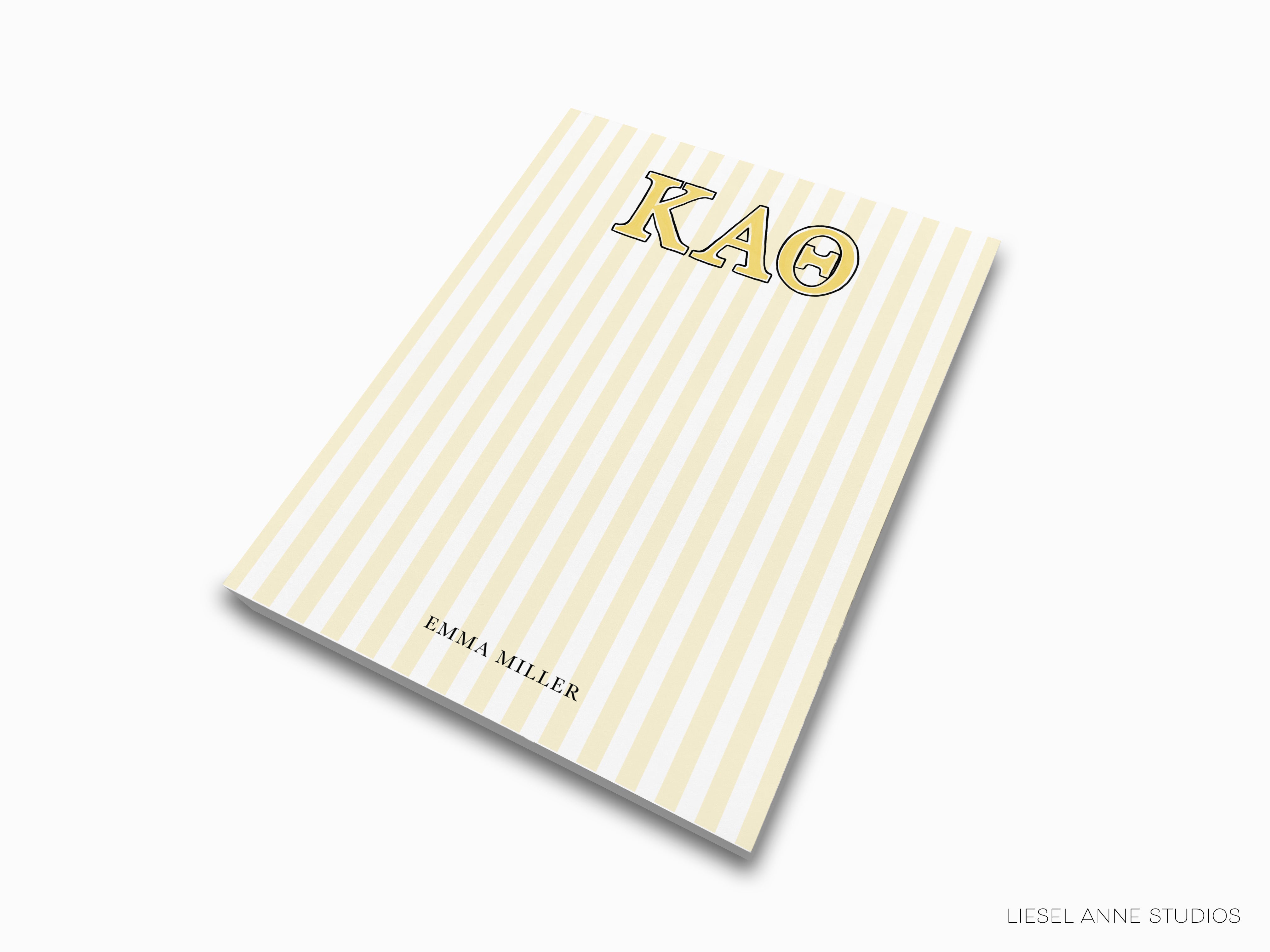 a yellow and white striped notebook with the word kao on it