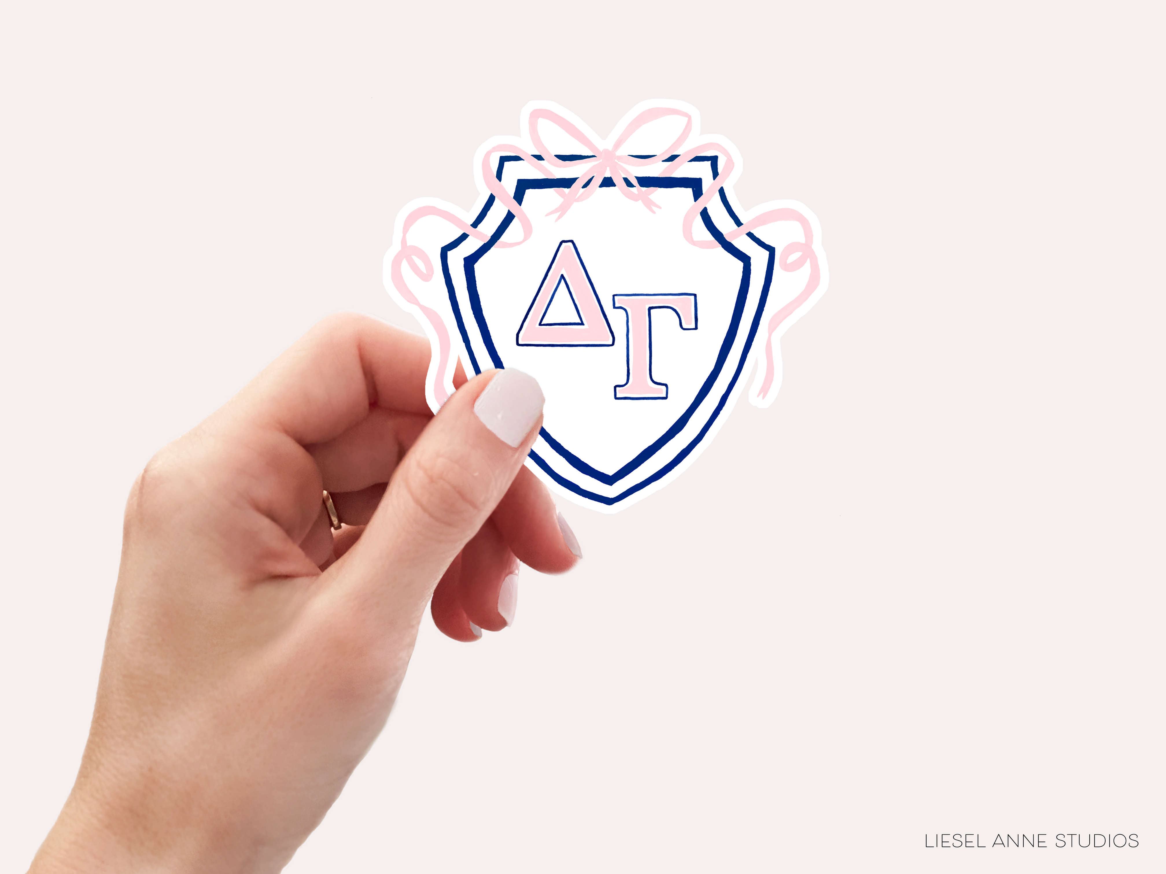 a hand holding a sticker with the letter a on it