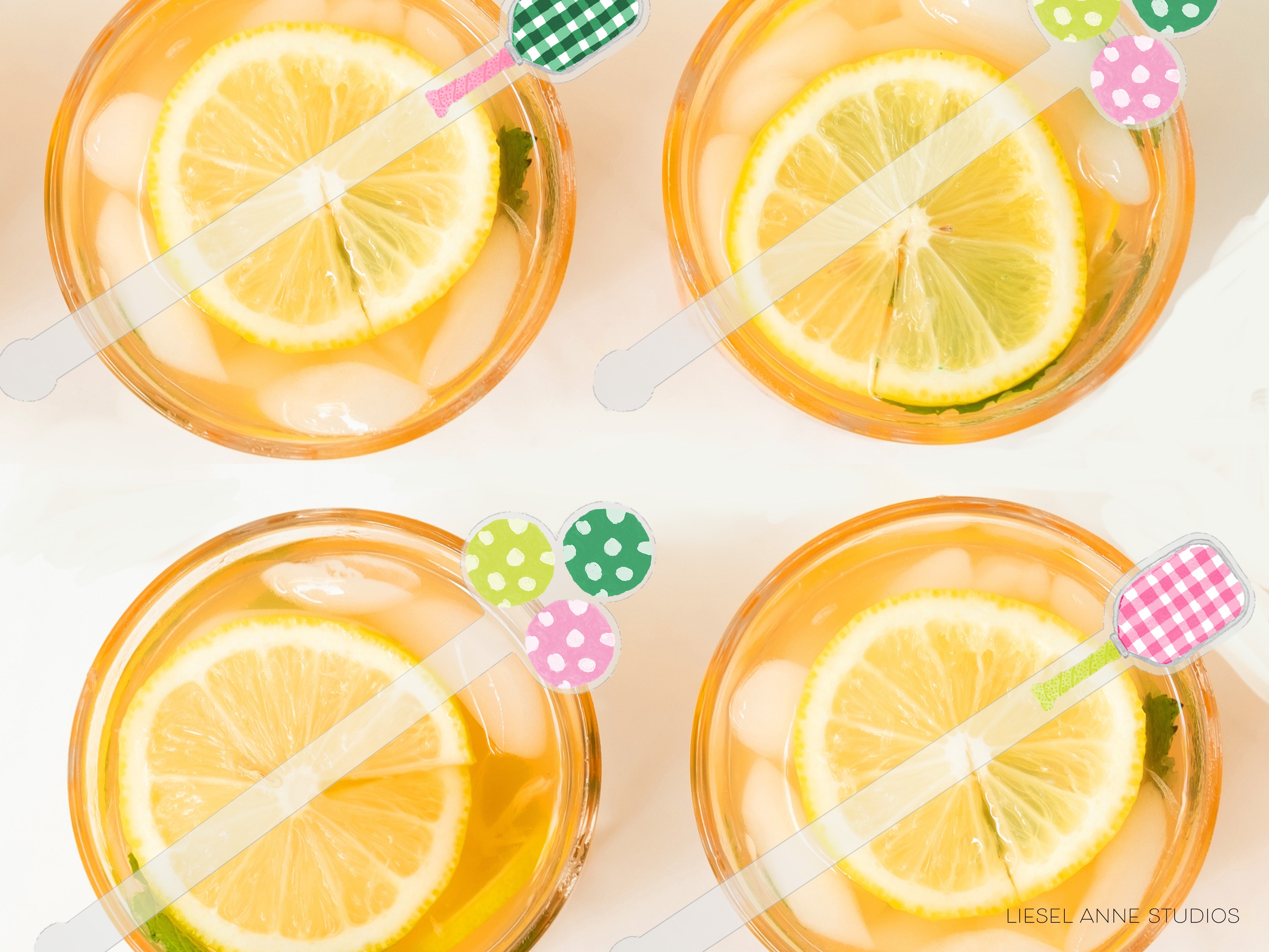 four glasses filled with a yellow liquid, each containing a slice of lemon. The glasses are accompanied by colorful straws with polka dot patterns.