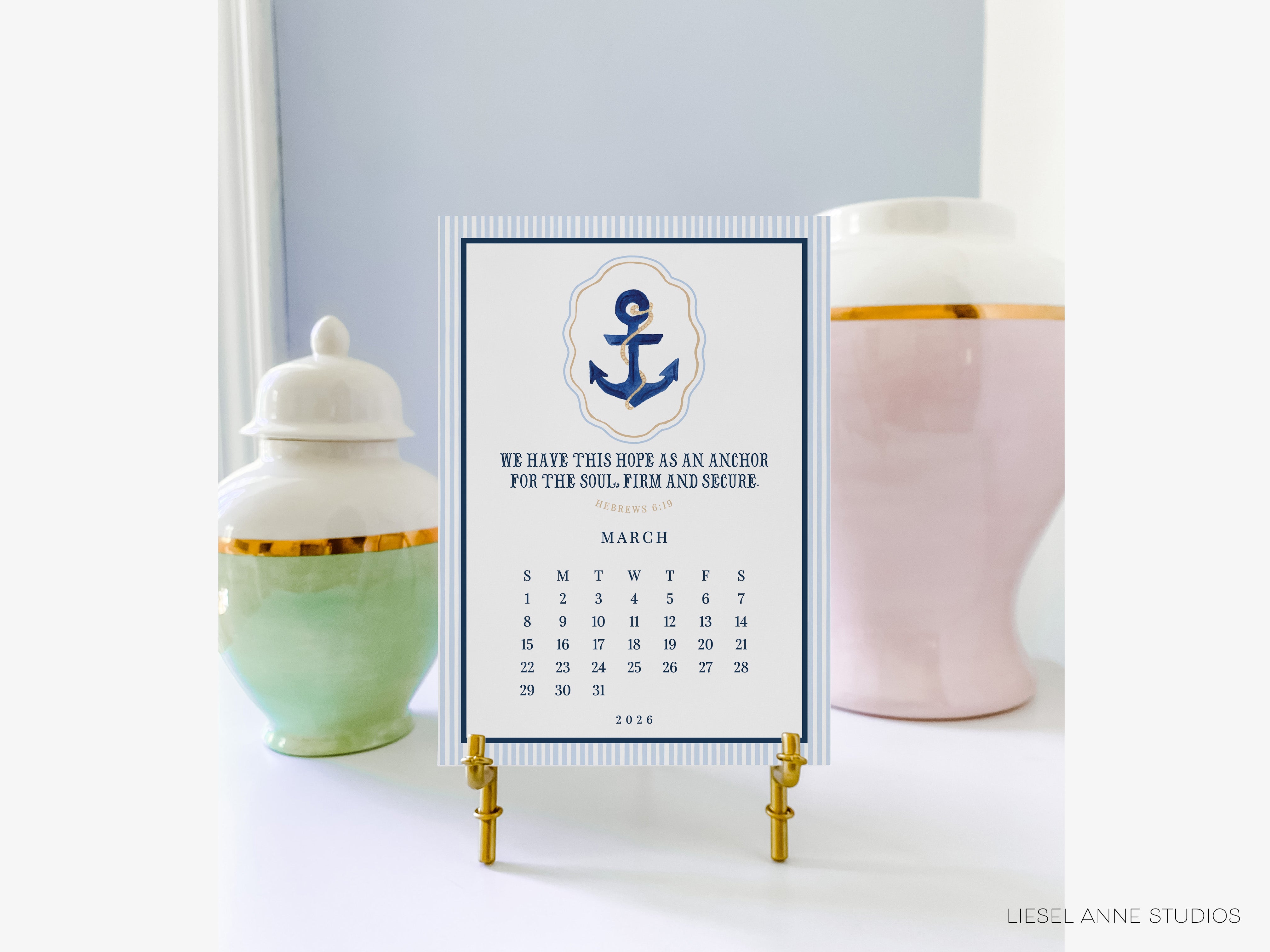 a calendar with a nautical theme, placed on a white surface between two decorative vases.