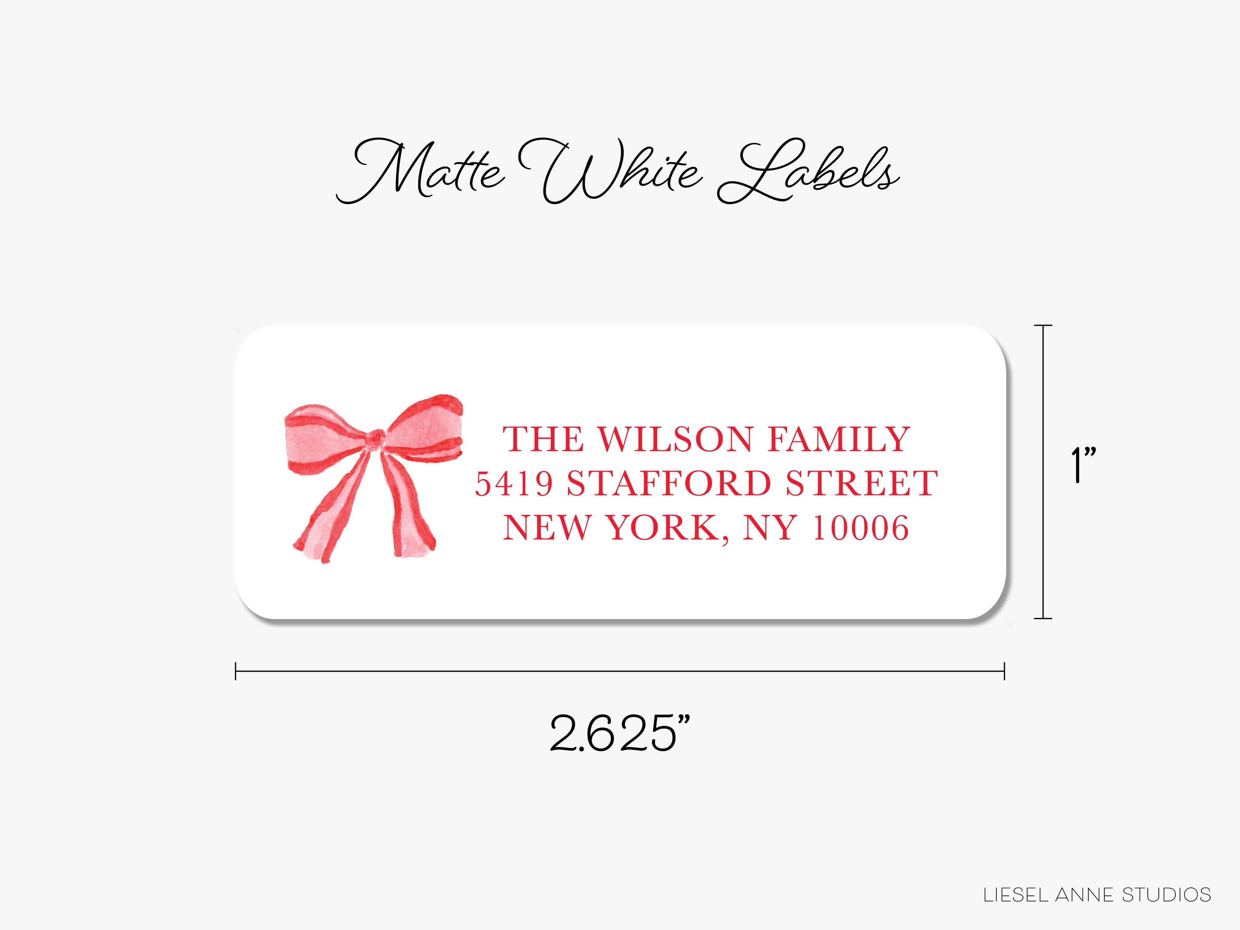 The image is a label for a package, with a bow on it. The label is white and measures 2.65 inches by 2.25 inches.