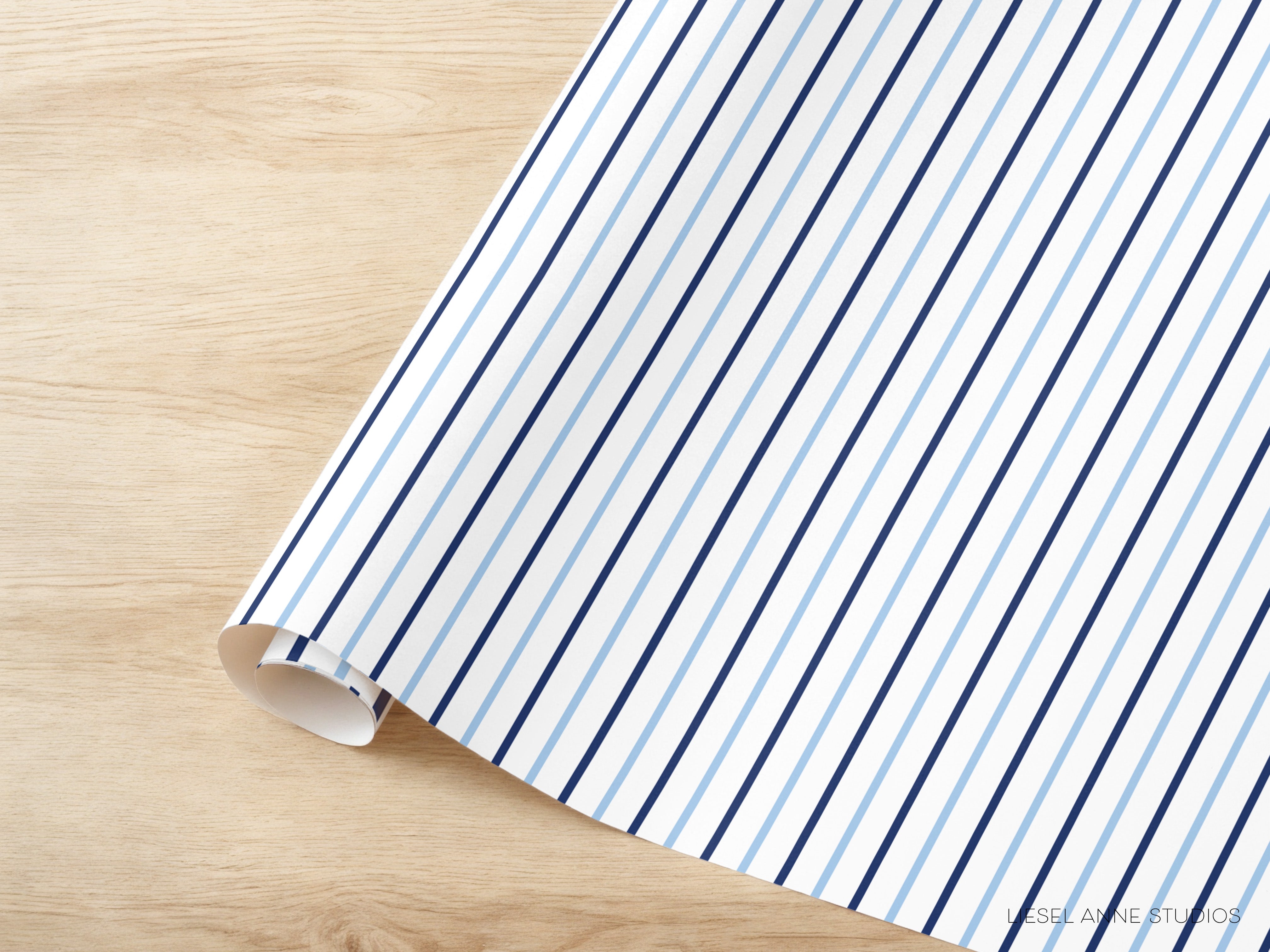 A roll of blue and white striped paper is placed on a wooden surface.