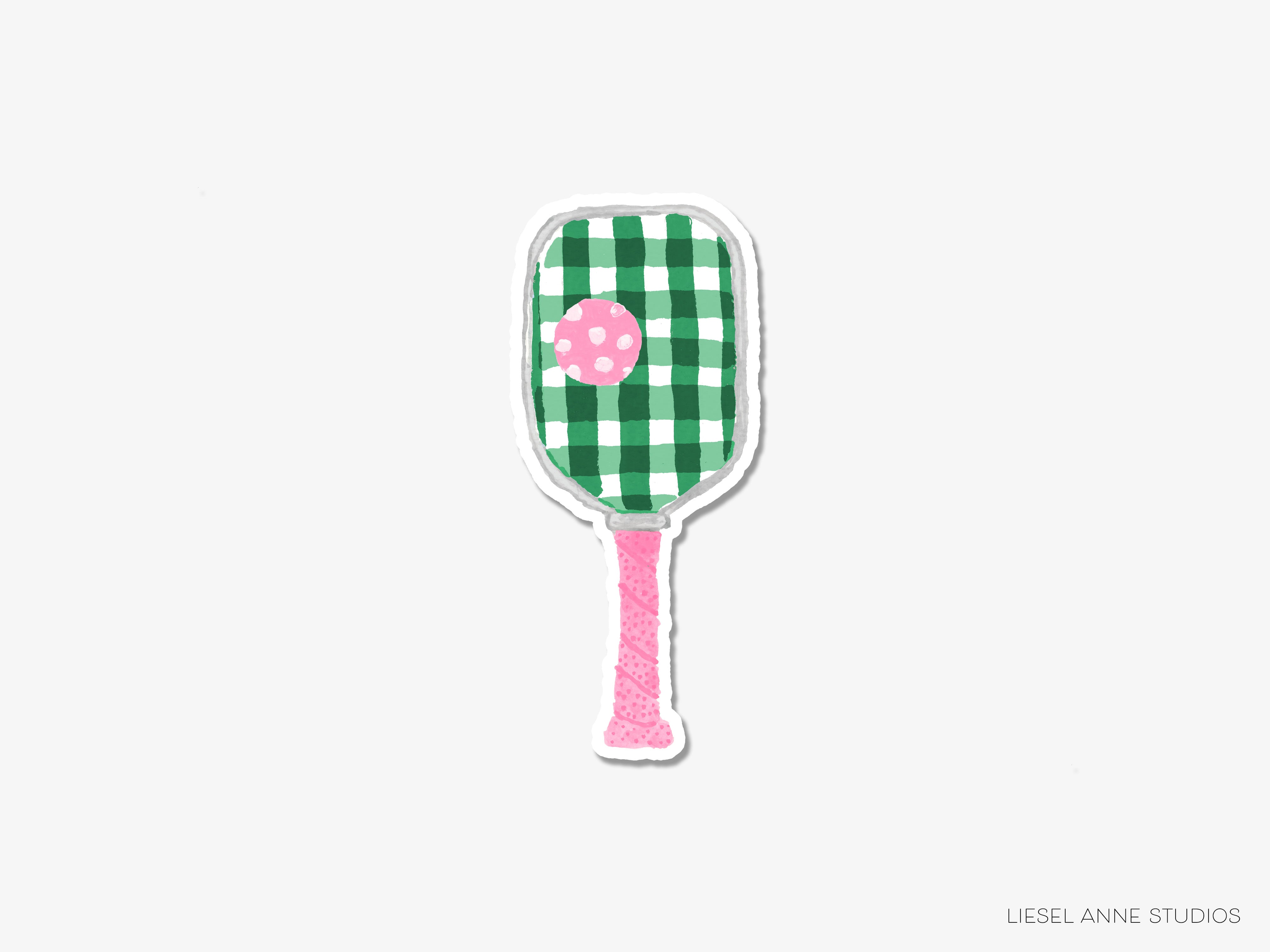 A green and white checkered paddle with a pink polka dot on it.