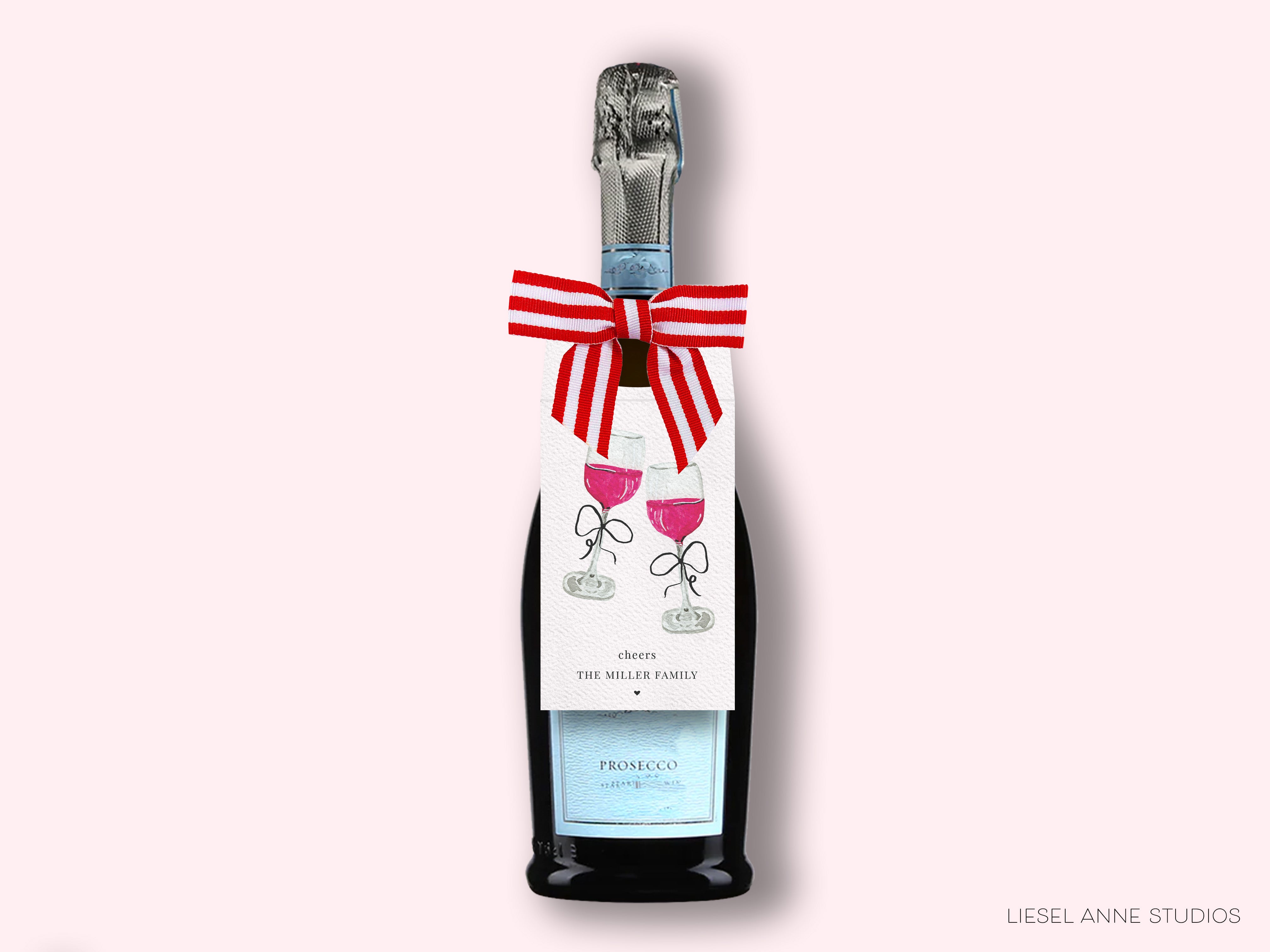 A bottle of Prosecco with a label featuring a red and white striped ribbon and illustrations of wine glasses.