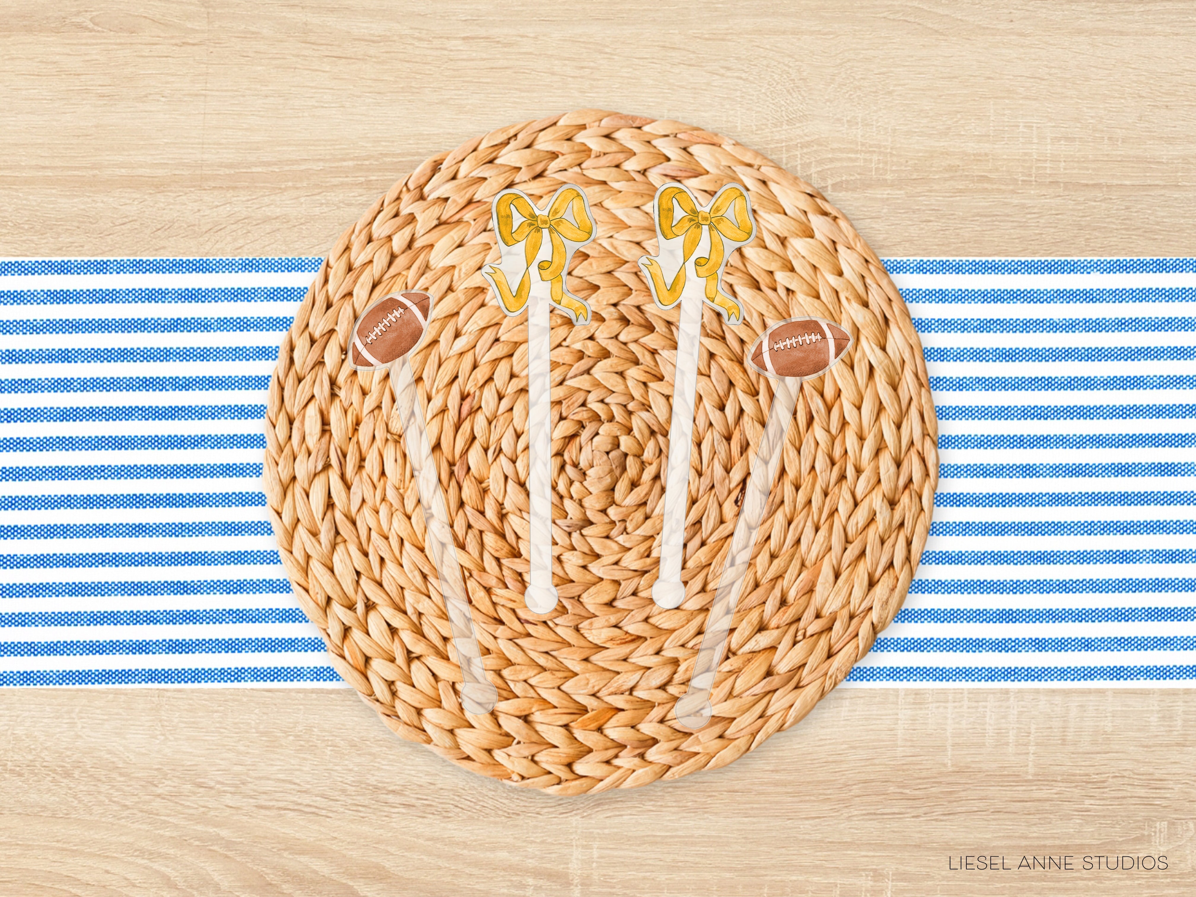 a woven placemat with a football motif, including two yellow and white football-shaped decorations and a brown football-shaped decoration. The placemat is placed on a blue and white striped tablecloth.