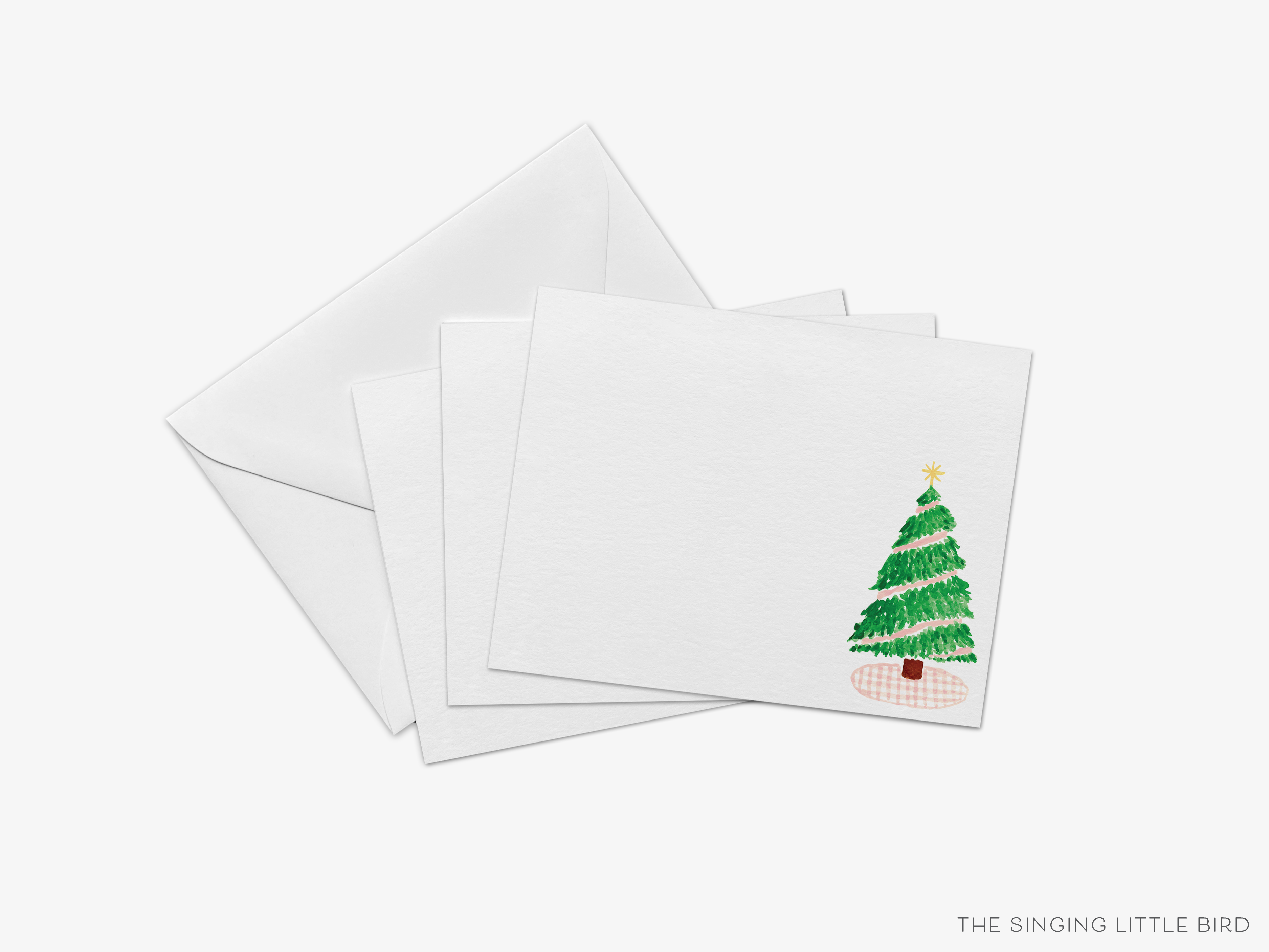 a set of white greeting cards with a Christmas tree design on the right side.
