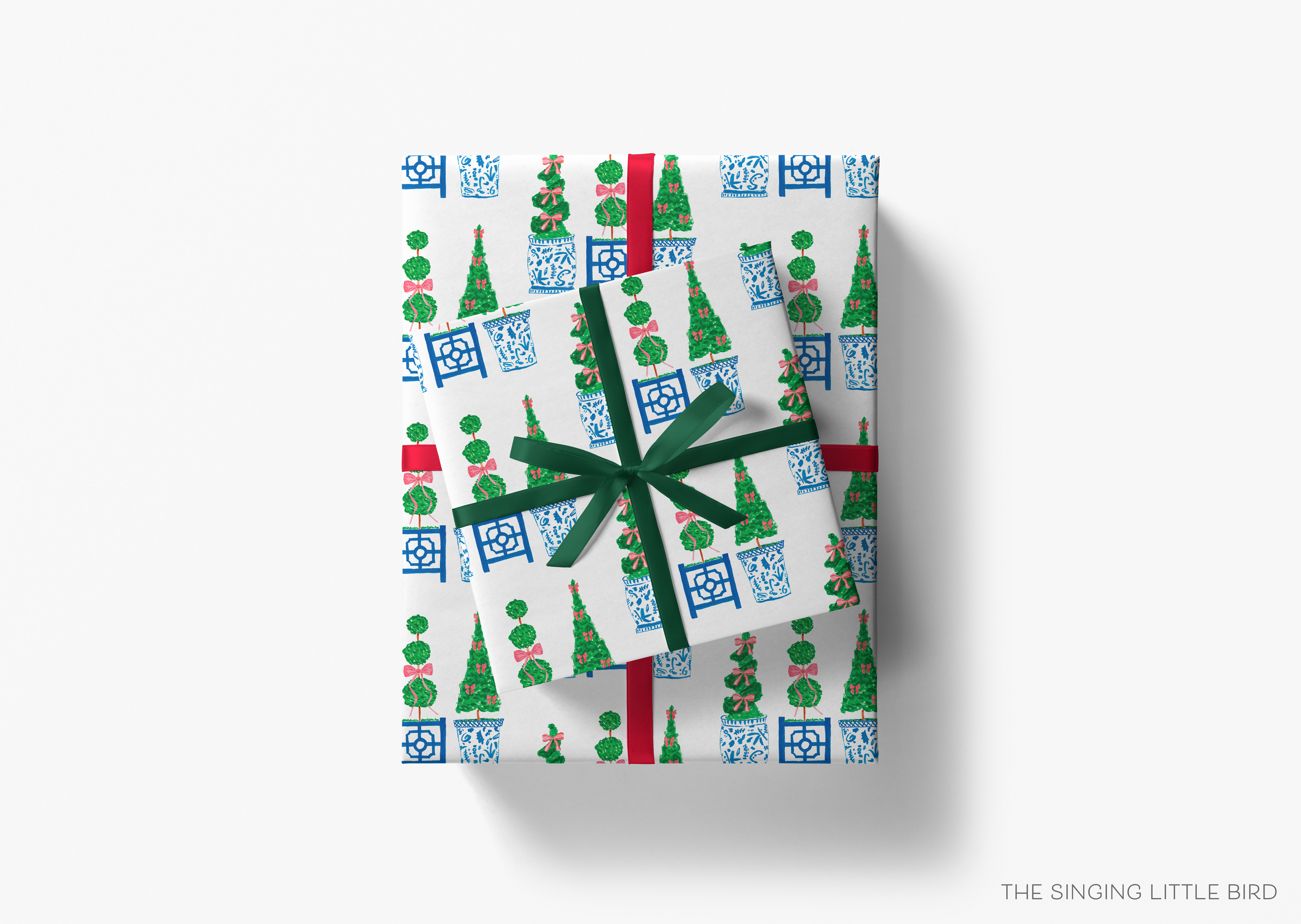 a gift box with a pattern of Christmas trees and blue and white ceramic or porcelain objects.