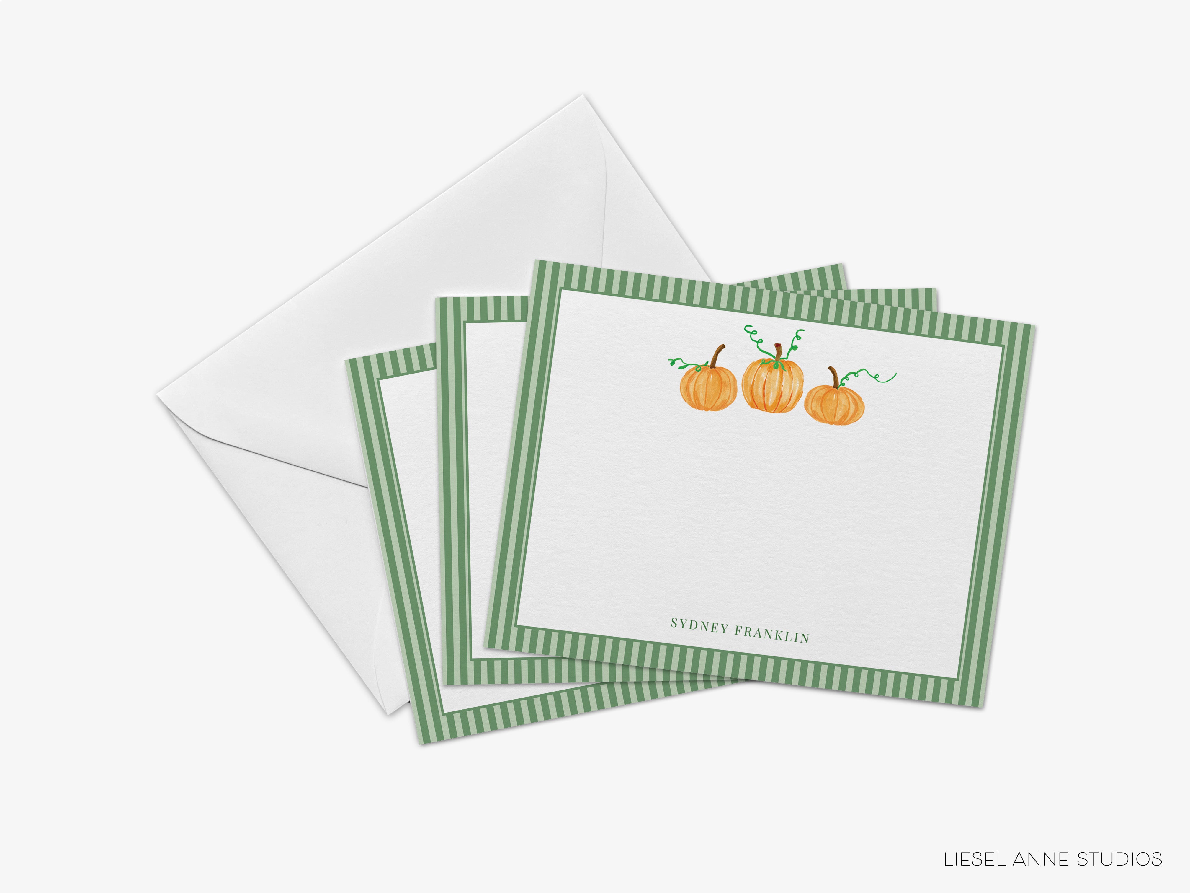 A set of green and white postcards with a pumpkin design, along with an envelope, is shown in the image.