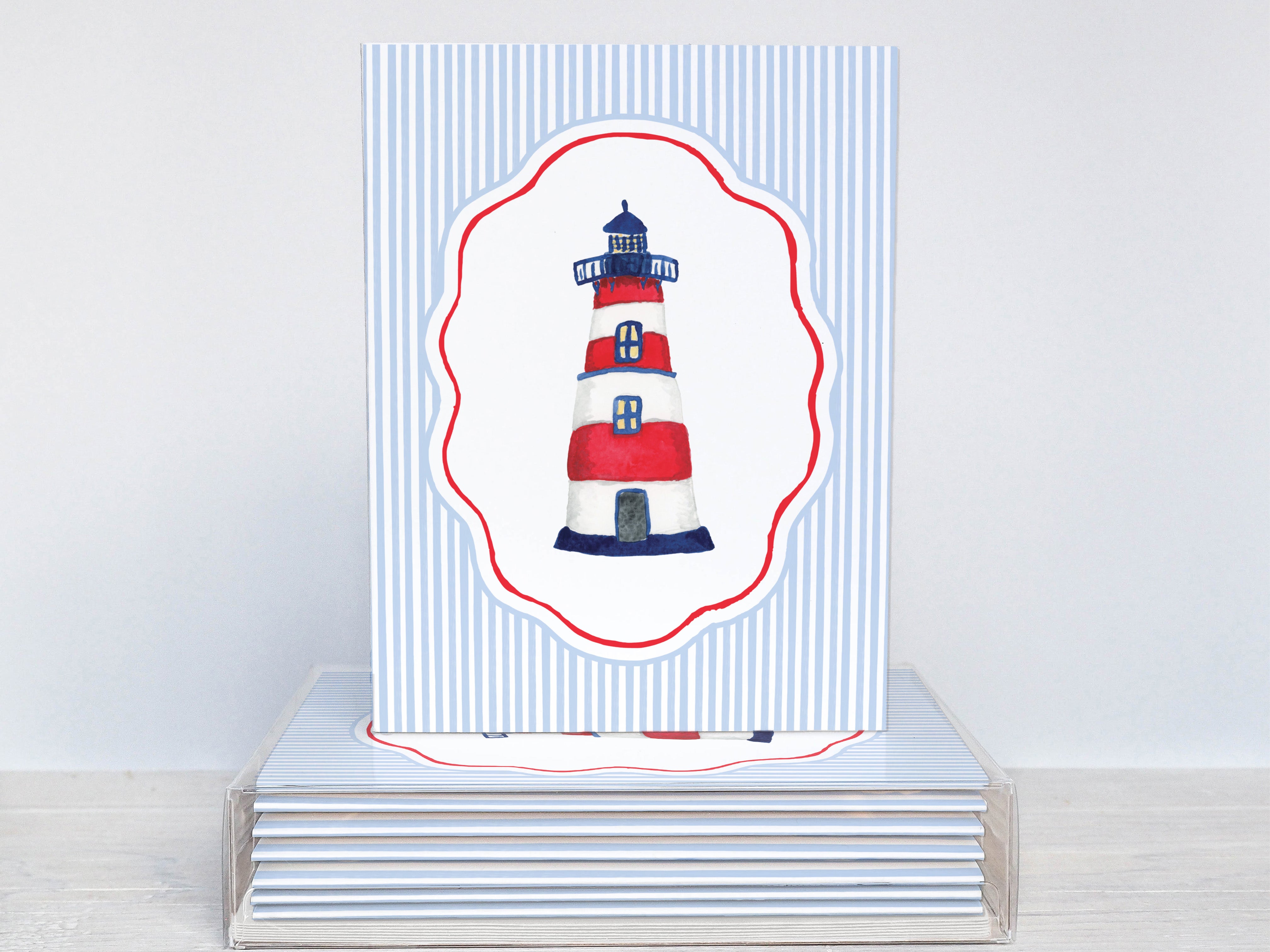A white and blue striped card with a lighthouse illustration on it.