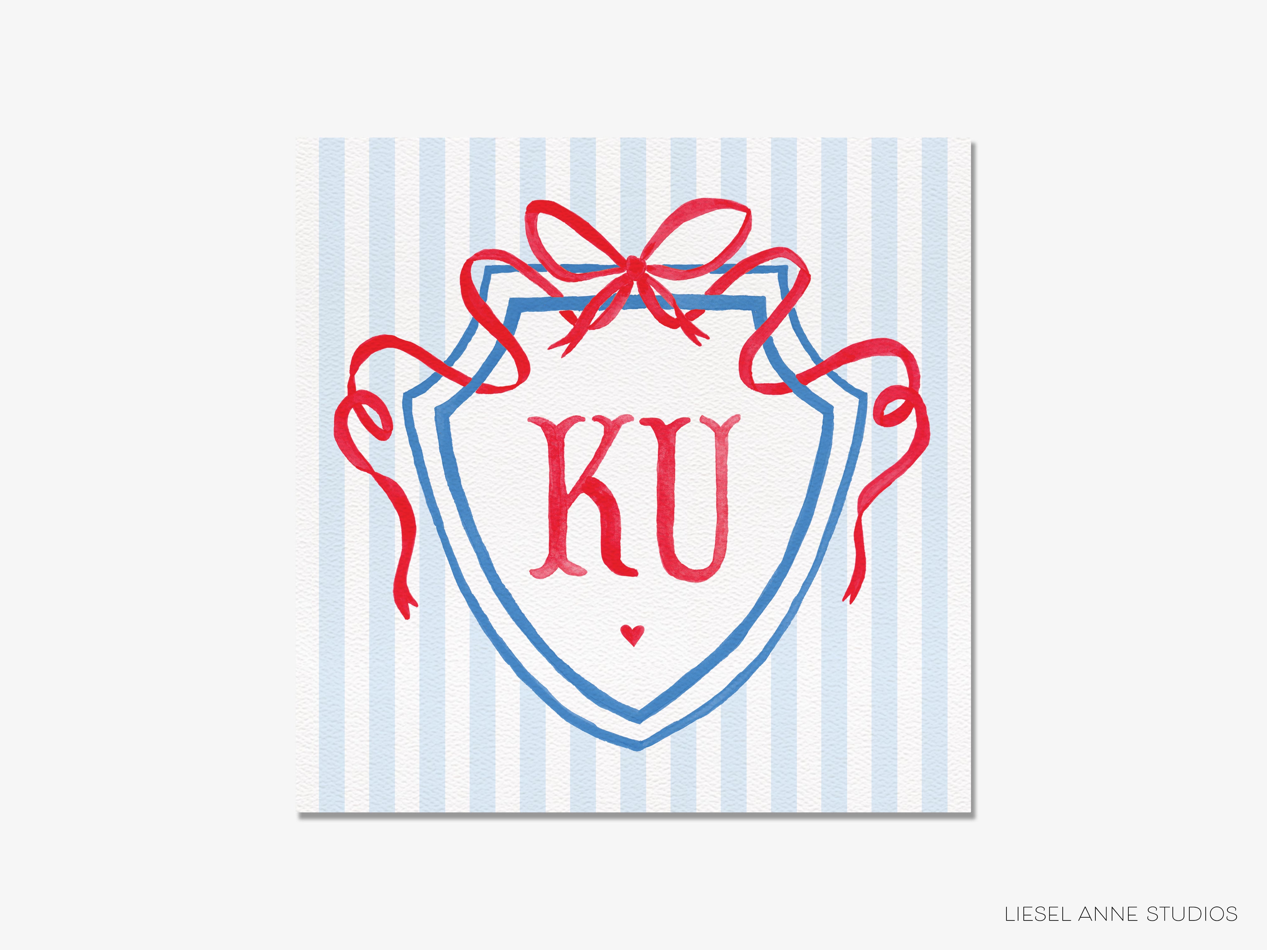 A shield-shaped logo with the initials "KU" in the center, surrounded by red ribbons.