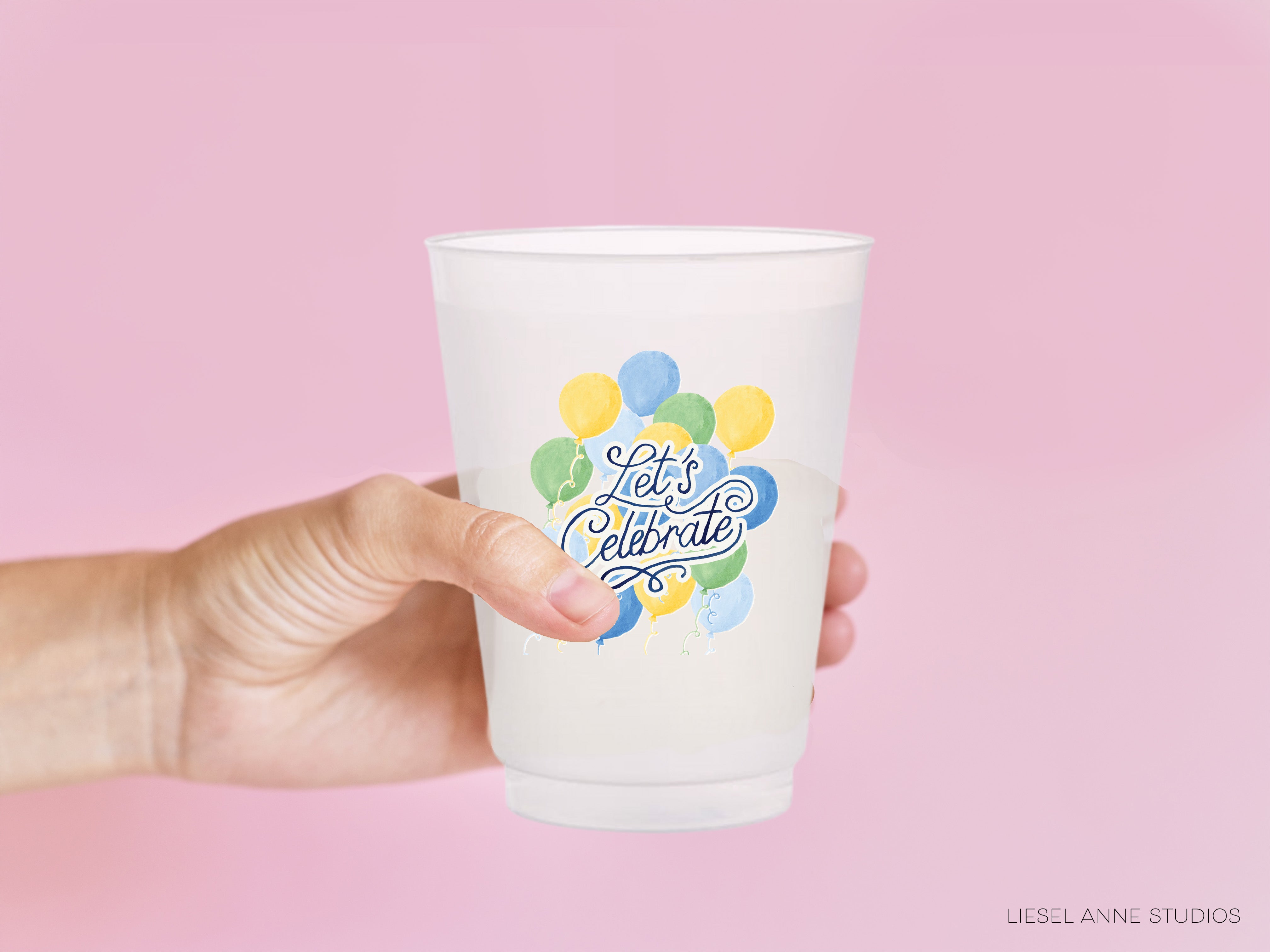 a person holding a plastic cup with balloons on it