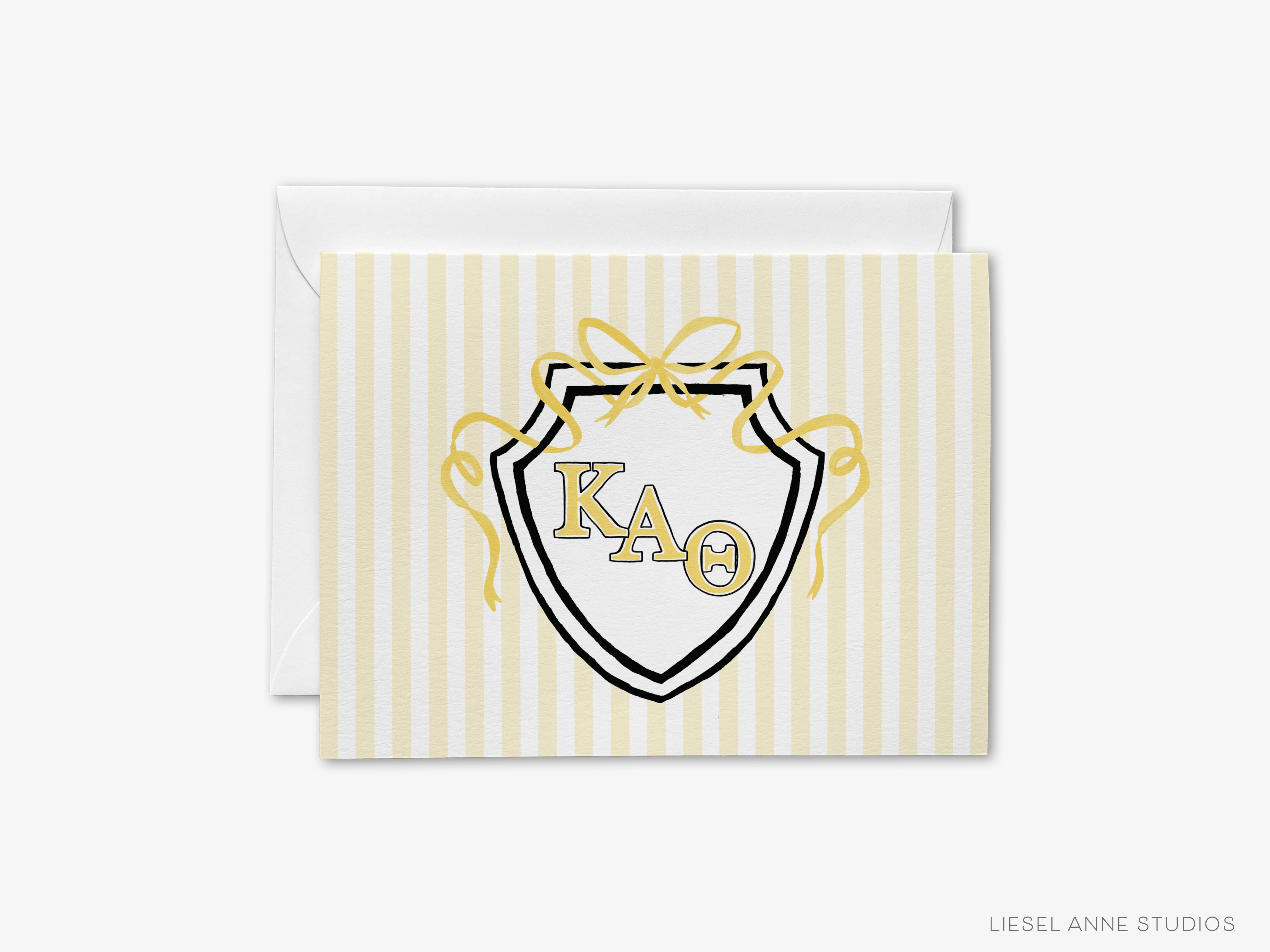 A greeting card with a shield-shaped design featuring the letters 'KA' in the center, surrounded by a decorative ribbon.