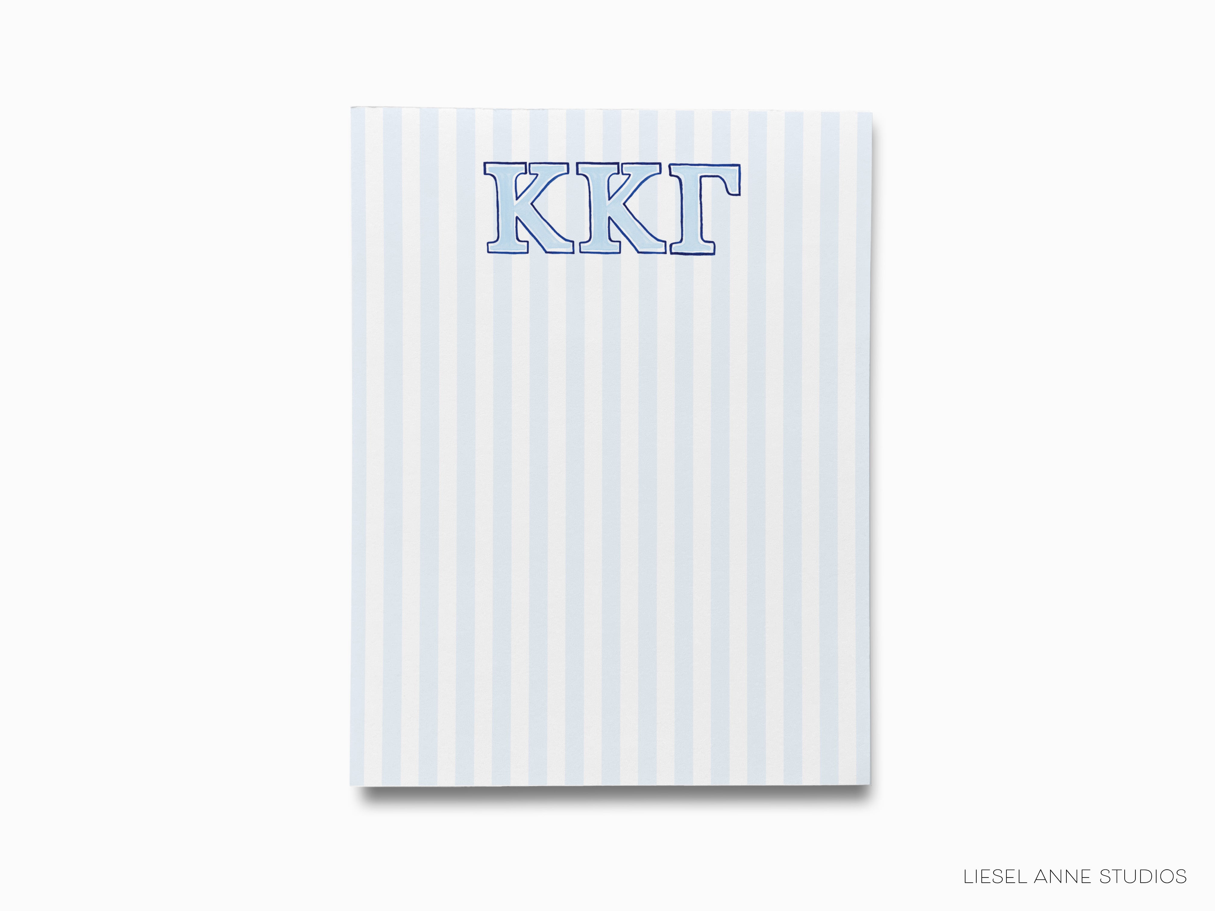 a blue and white striped notebook with the letter kkt on it