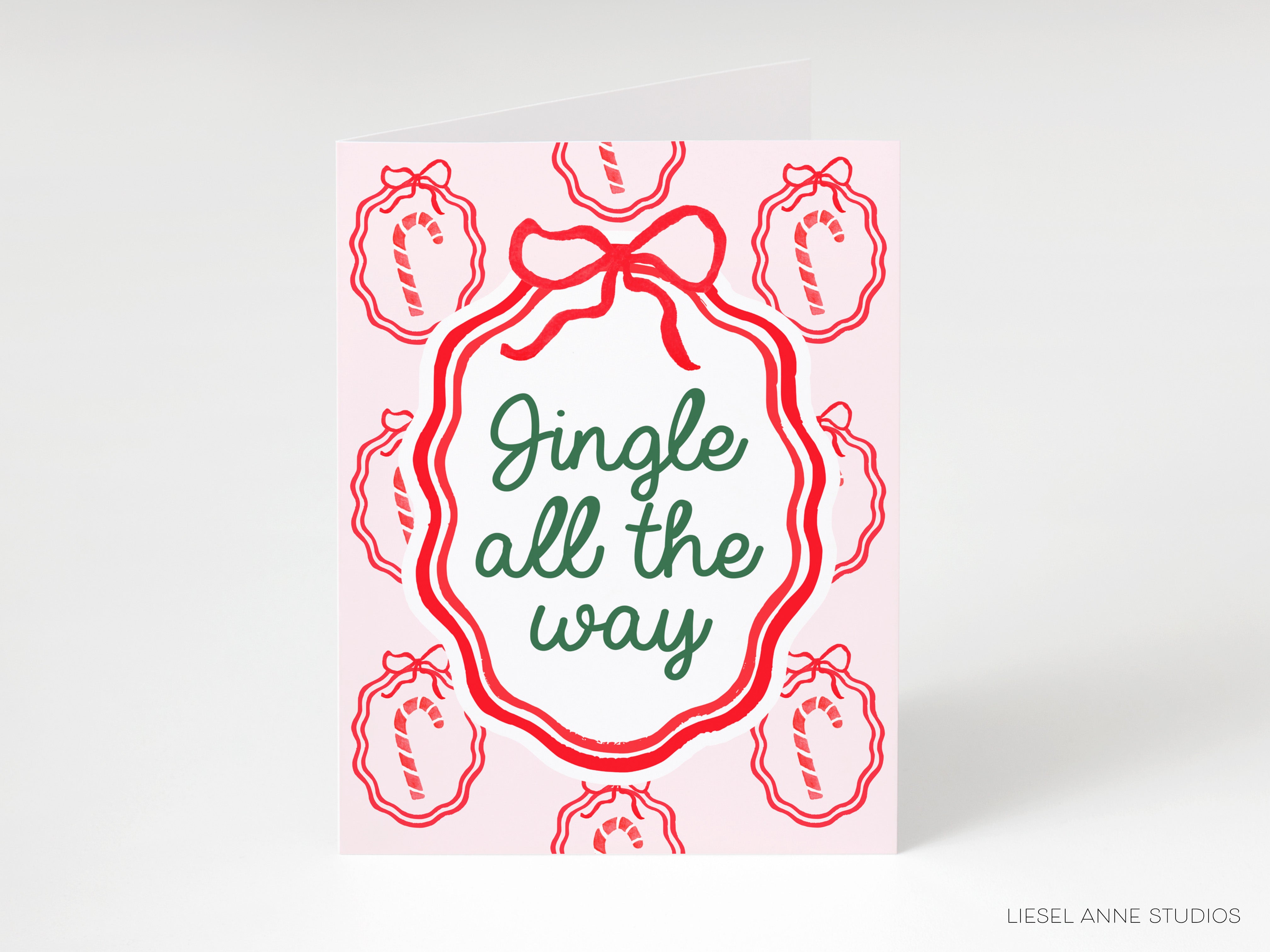 A greeting card with a jingle all the way design, featuring red and white elements and the text "Jingle all the way".