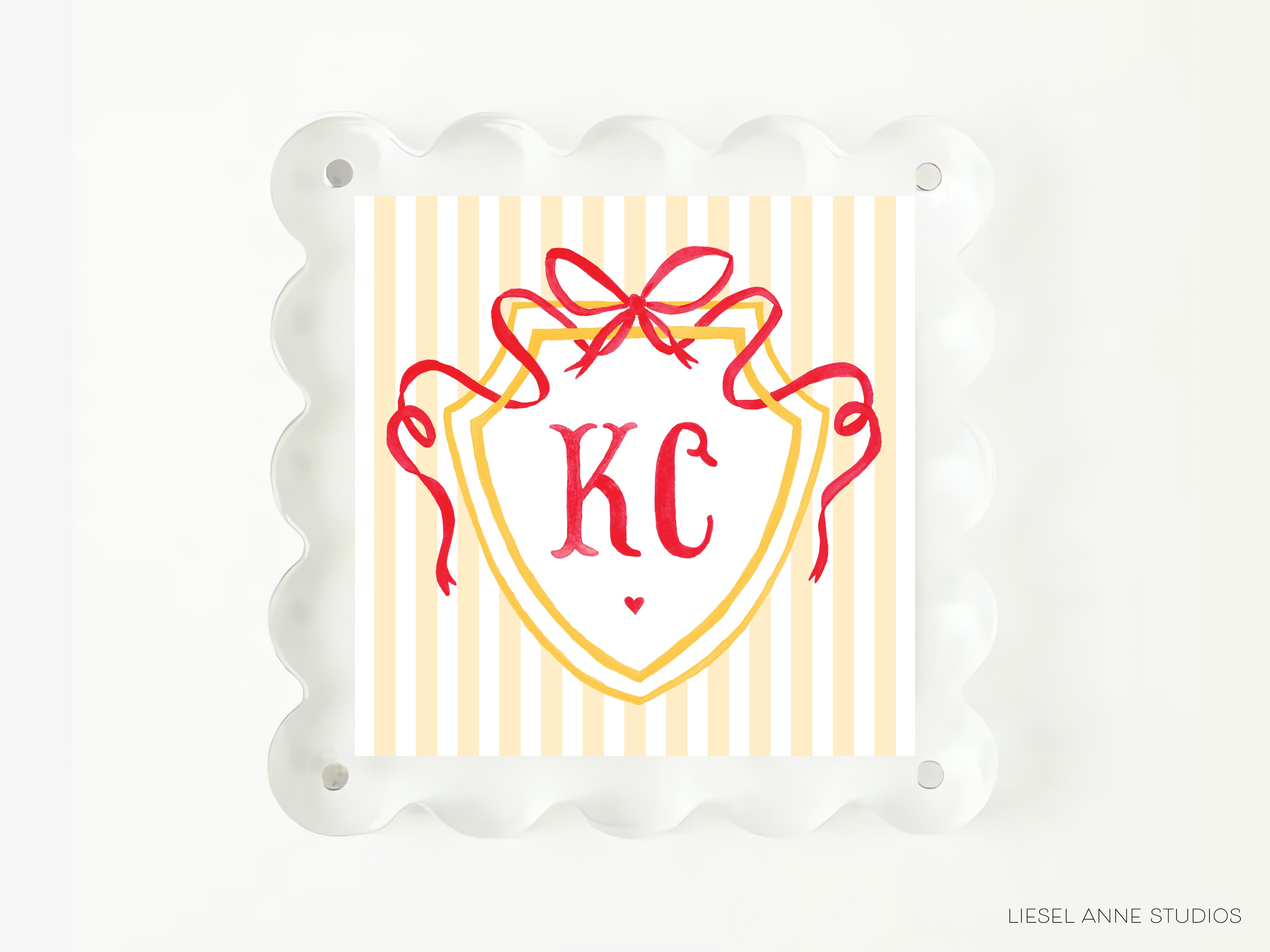 A square image with a yellow and white striped background, featuring a red ribbon and a shield-shaped design with the initials "KC" prominently displayed.