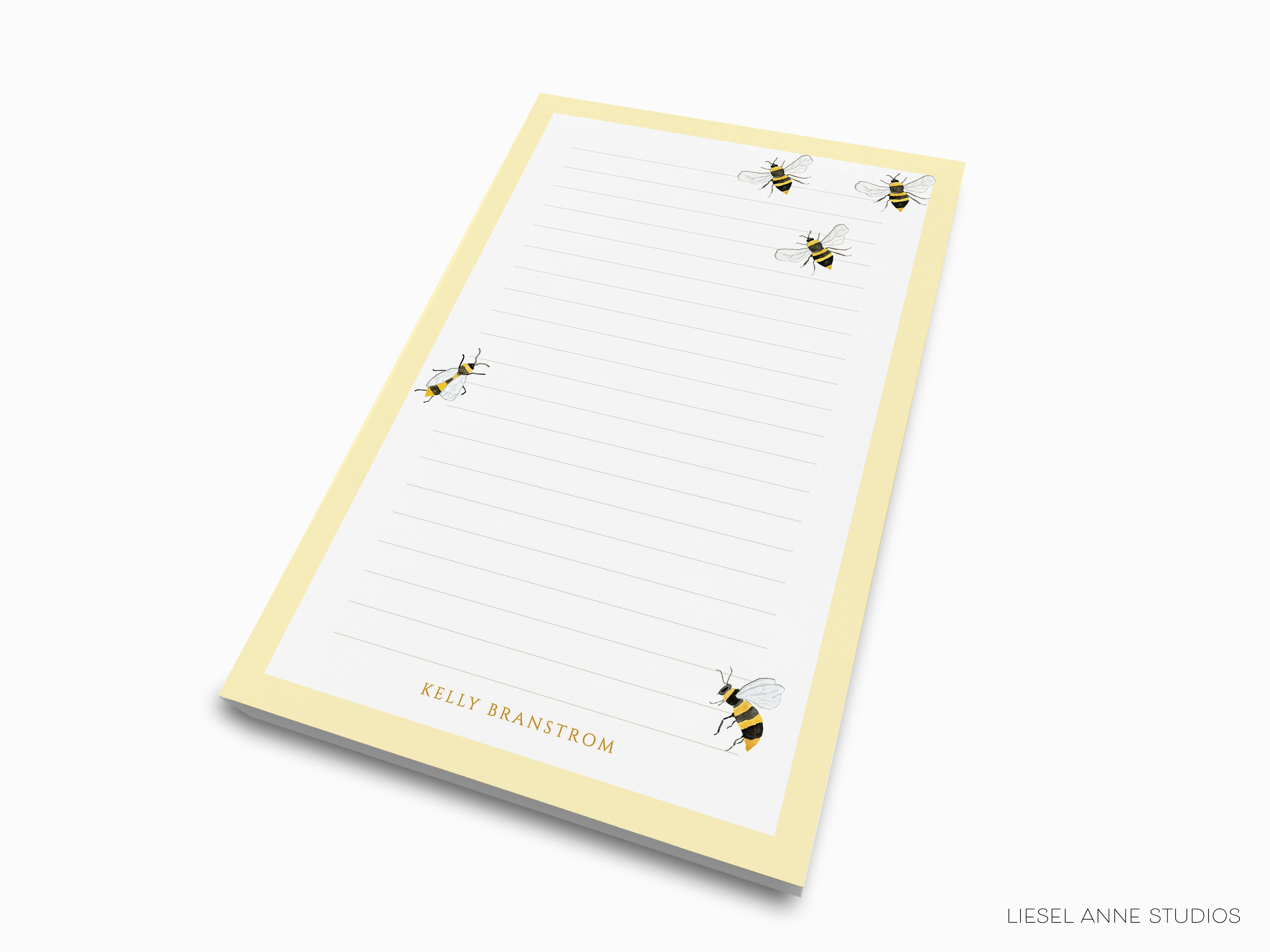 a yellow lined paper pad with a repeating pattern of bees on it.