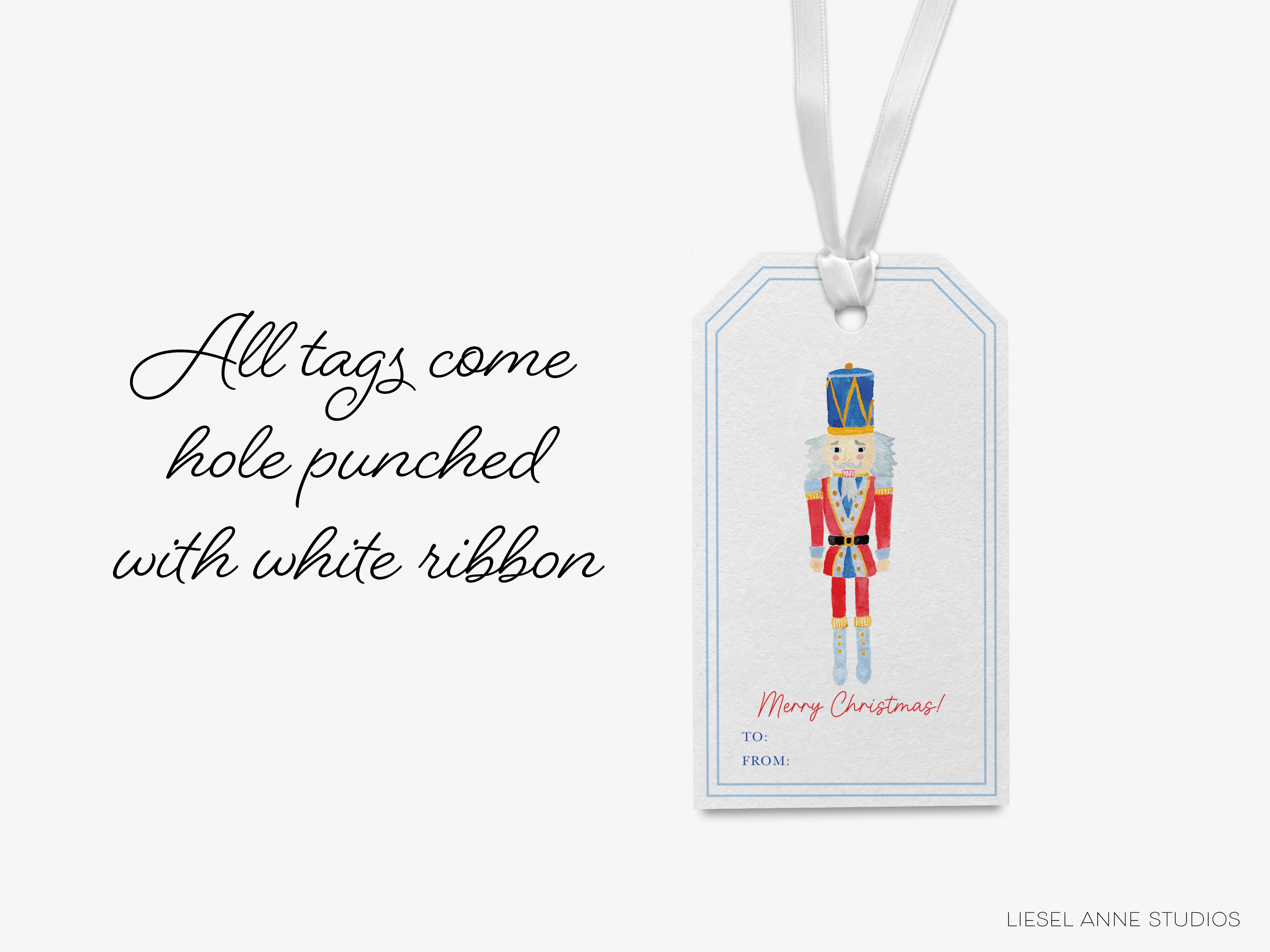 A white ribbon tag with a nutcracker illustration and the text "Merry Christmas!" attached to it.