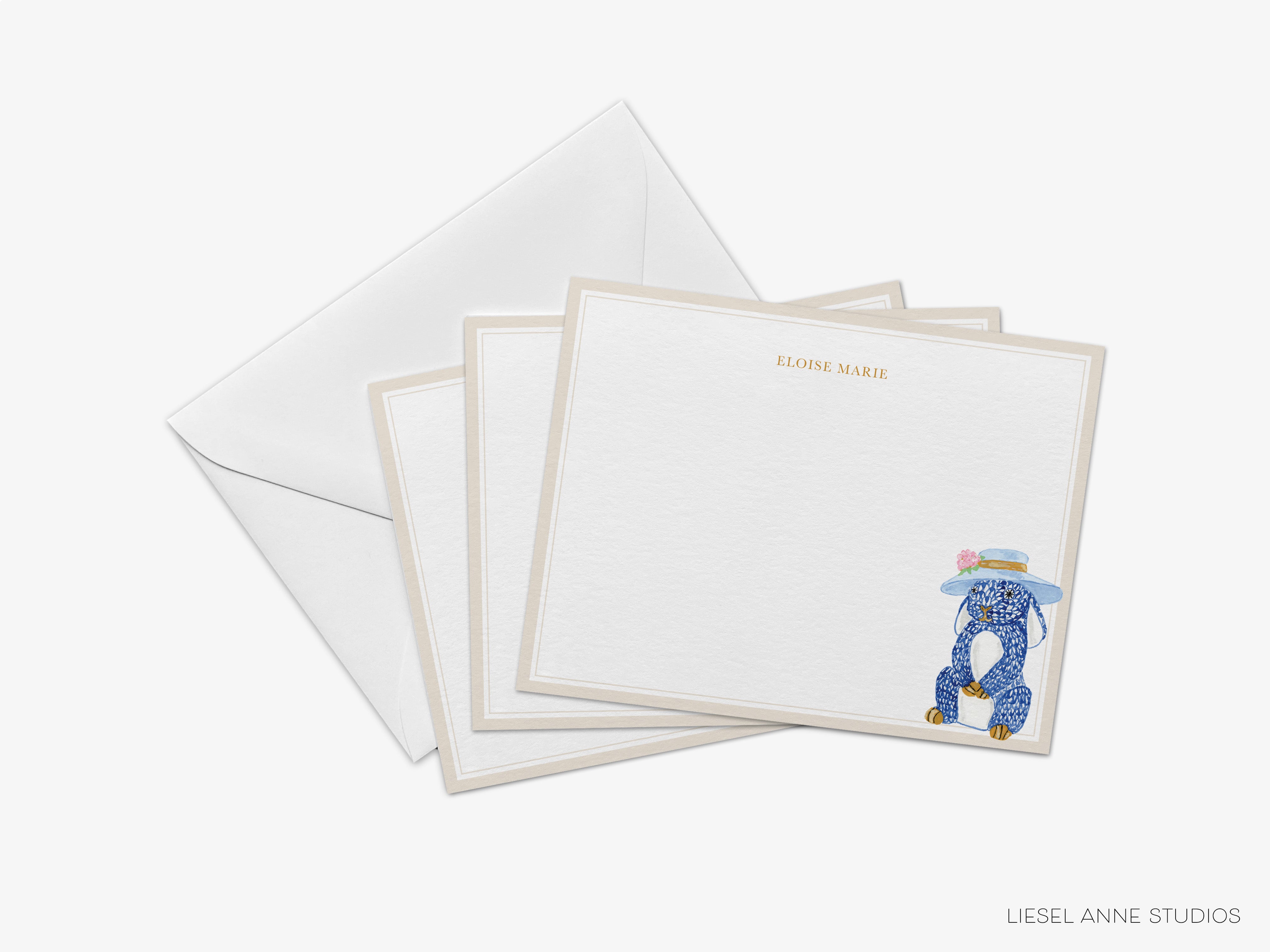 a set of white postcards with a blue elephant illustration on them, along with a white envelope.