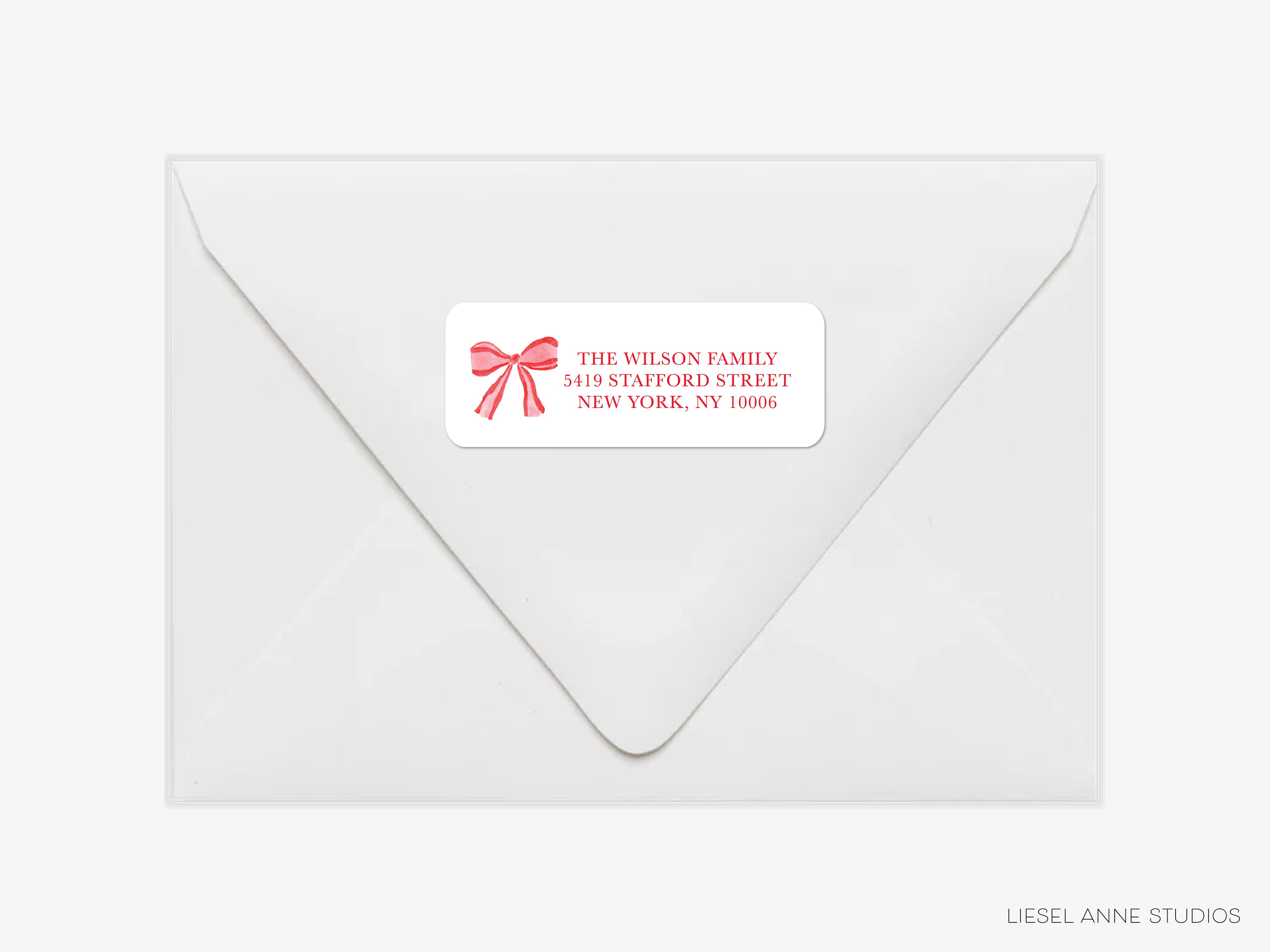 a white envelope with a red ribbon label on it, which appears to be a personalized or custom-made envelope.