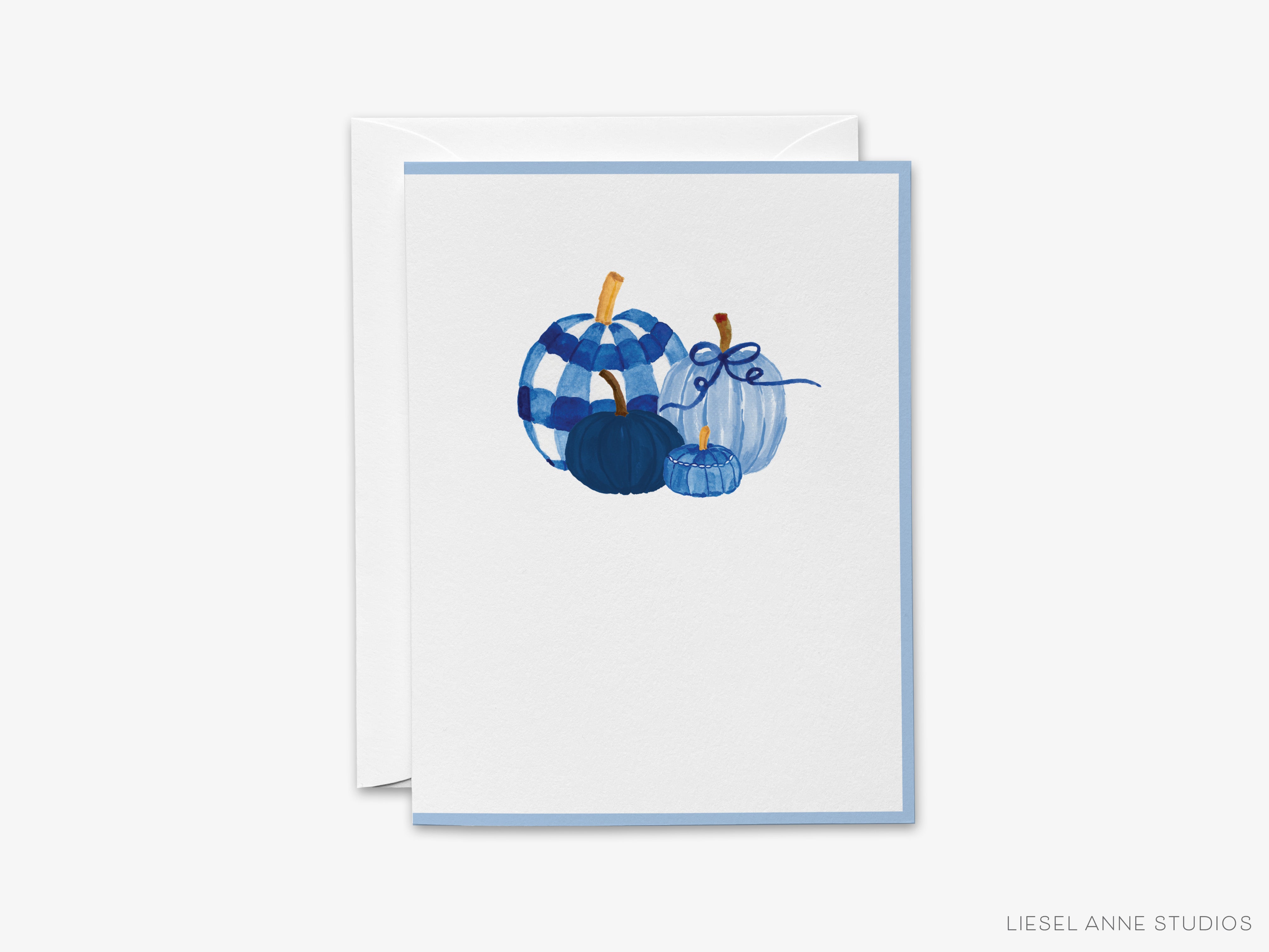 A white card with a blue and white illustration of three pumpkins on it.