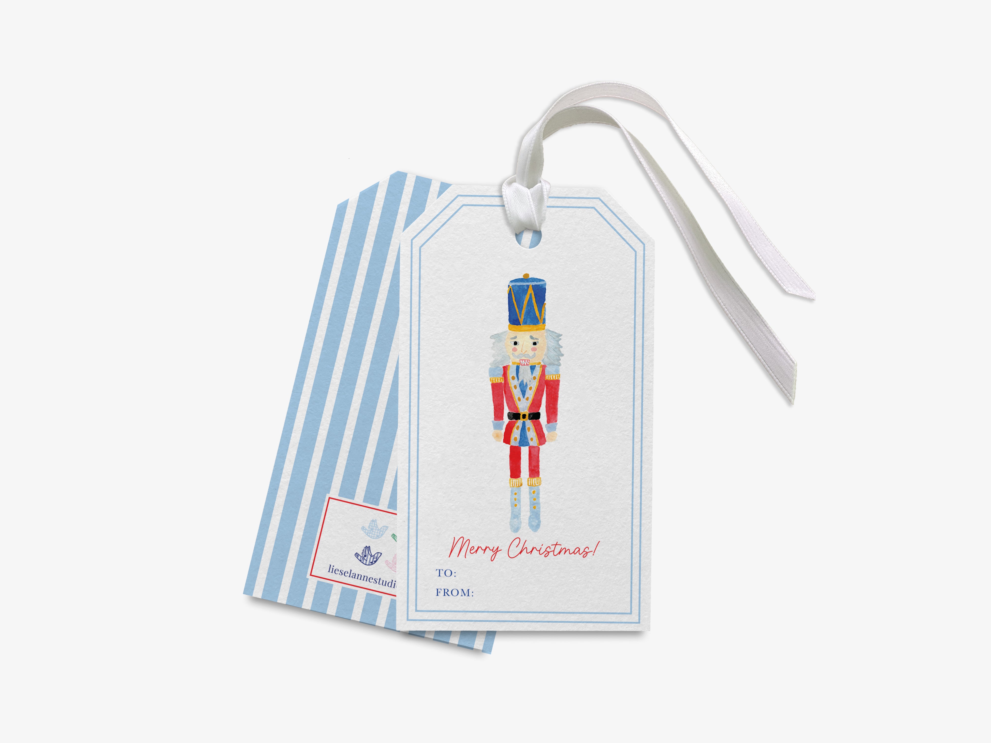 A white gift tag with a blue stripe and a nutcracker illustration on it.