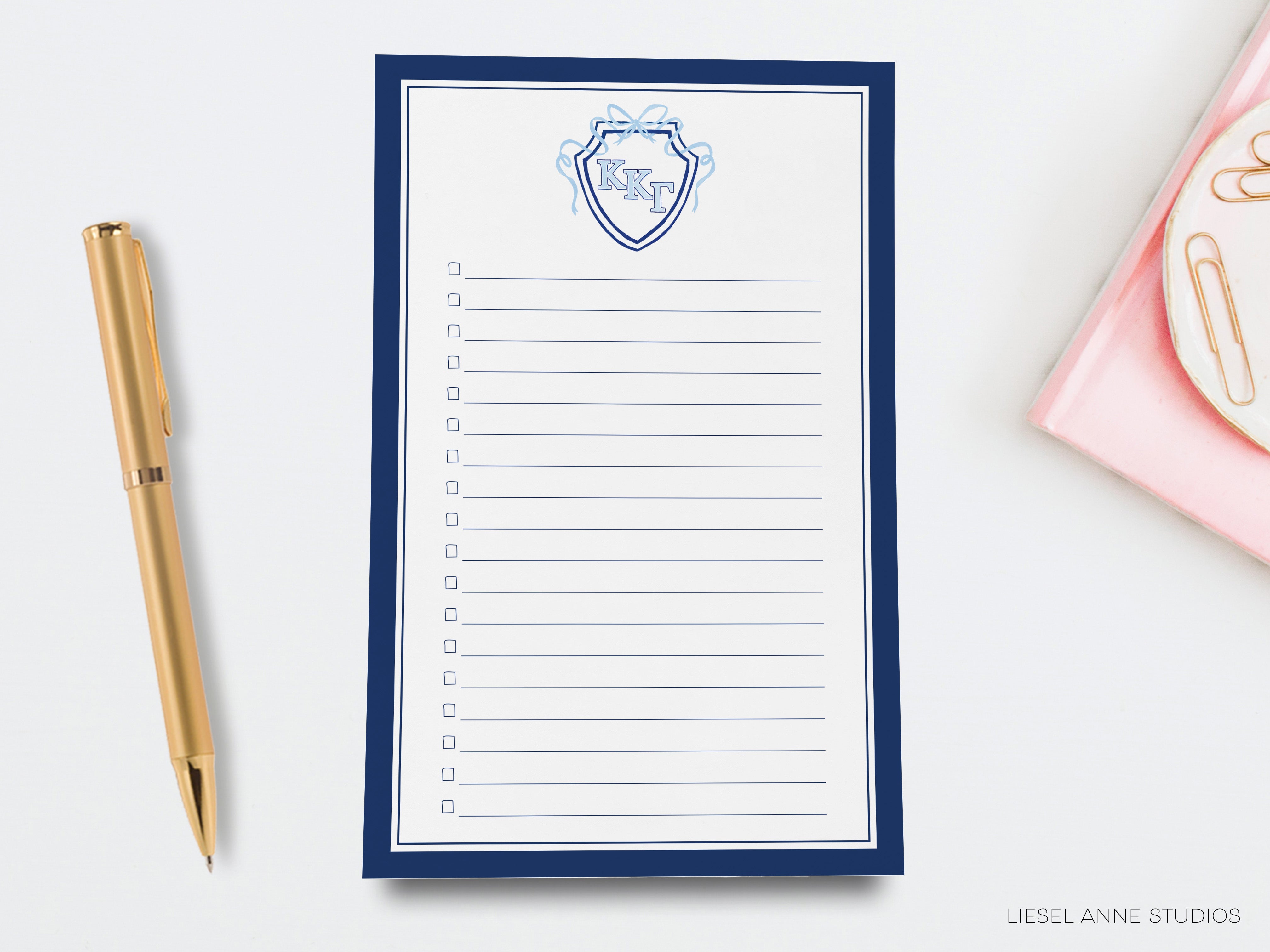 a notepad with a picture of a shield on it next to a pen