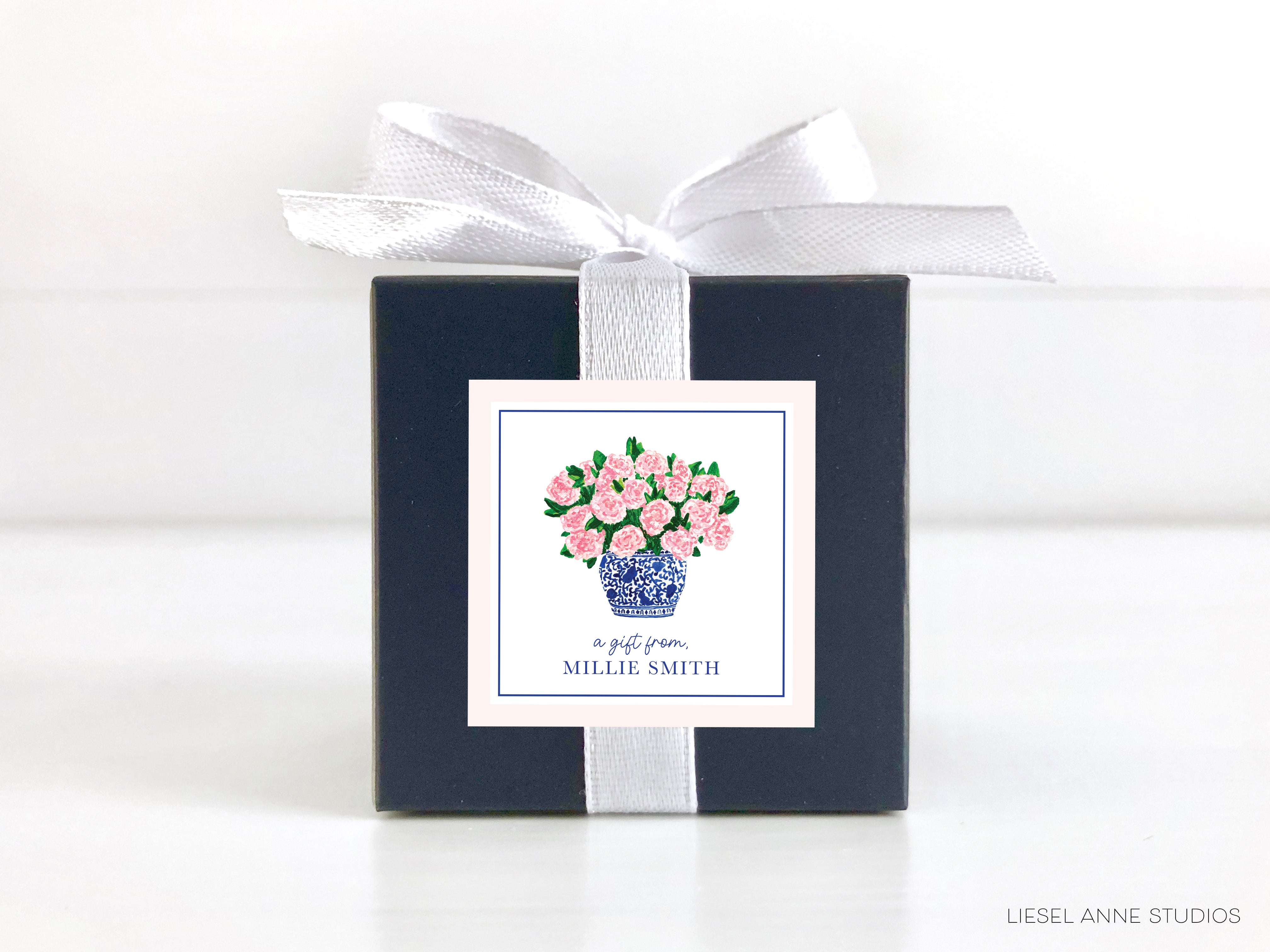 a blue and white box with pink flowers in it