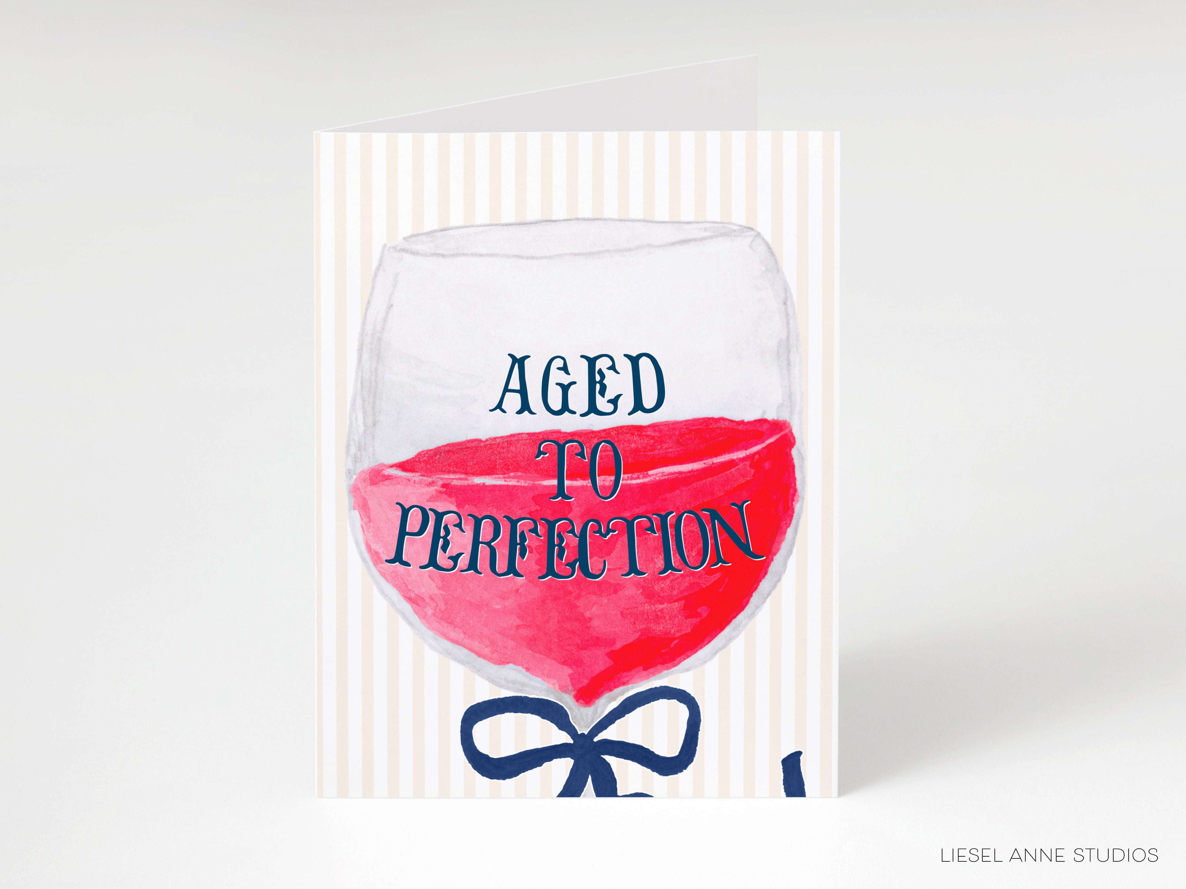 a card with a wine glass illustration and the text "AGED TO PERFECTION" written on it.