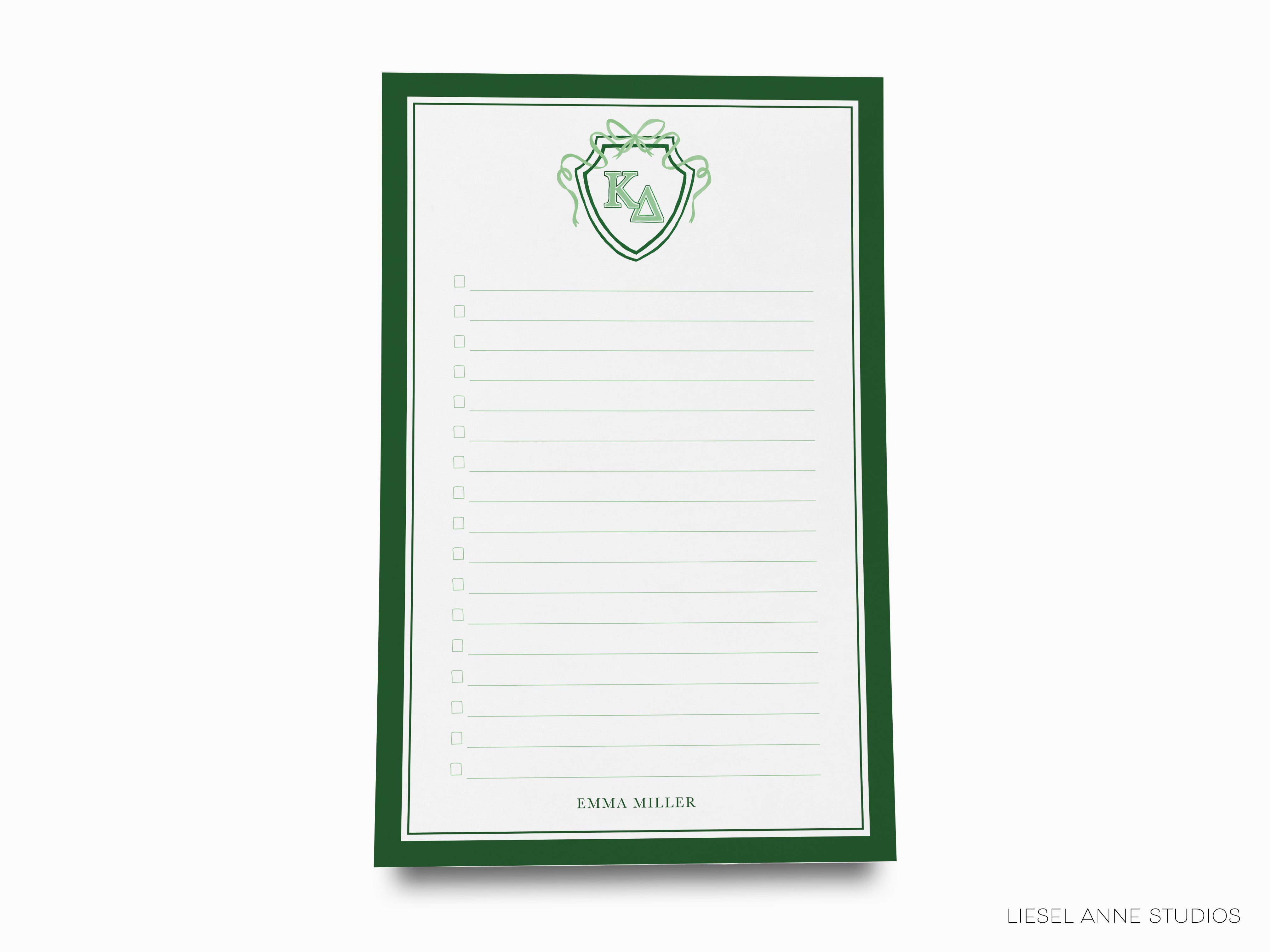 a notepad with a green and white design on it
