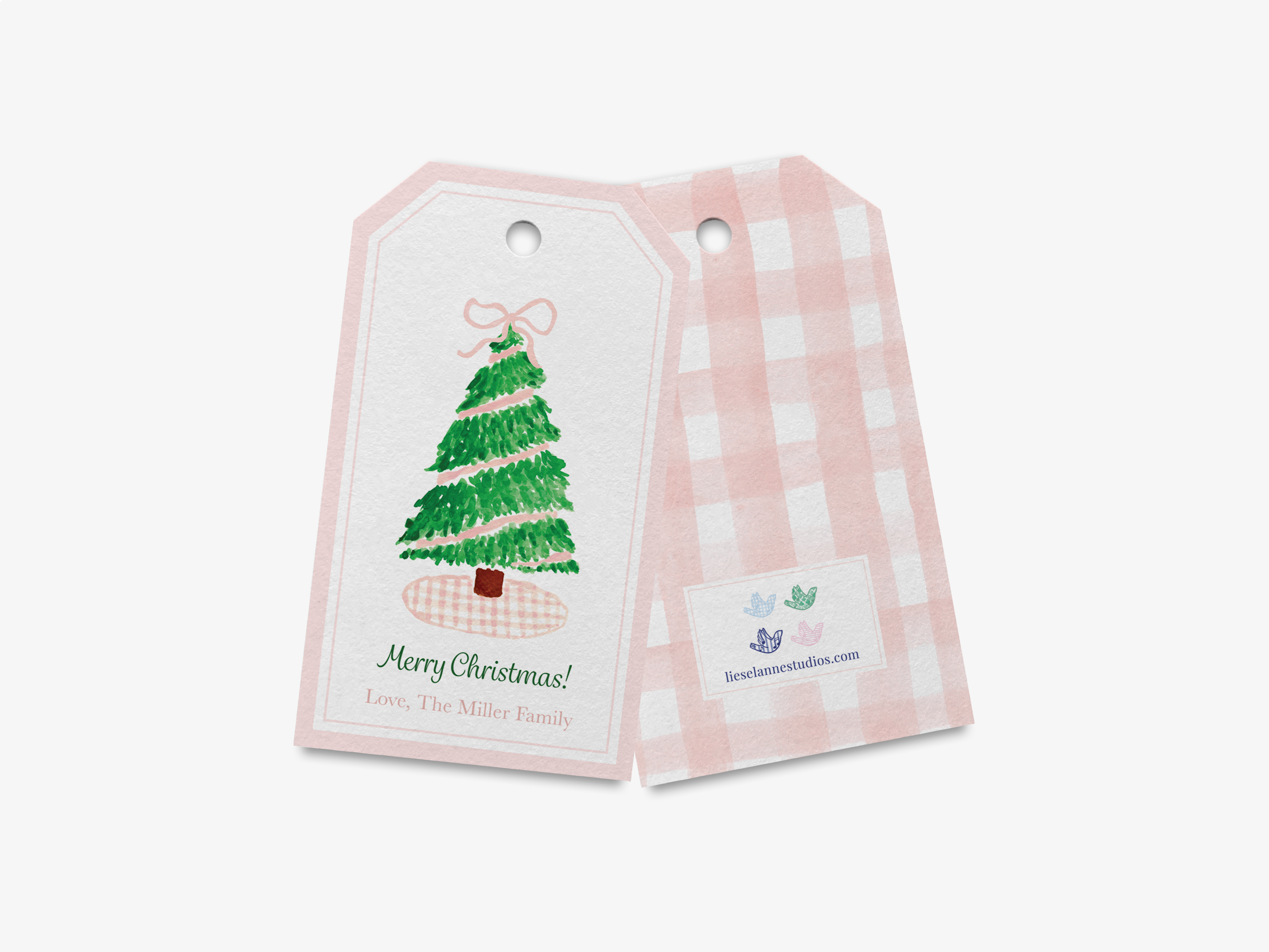 a pair of Christmas tree tags, one with a pink and white checkered background and the other with a pink and white checkered background. The tag on the left has a Christmas tree illustration and the text "Merry Christmas! Love, The Miller Family" written below it. The tag on the right has a small logo and text that reads "lesenlannies.com".