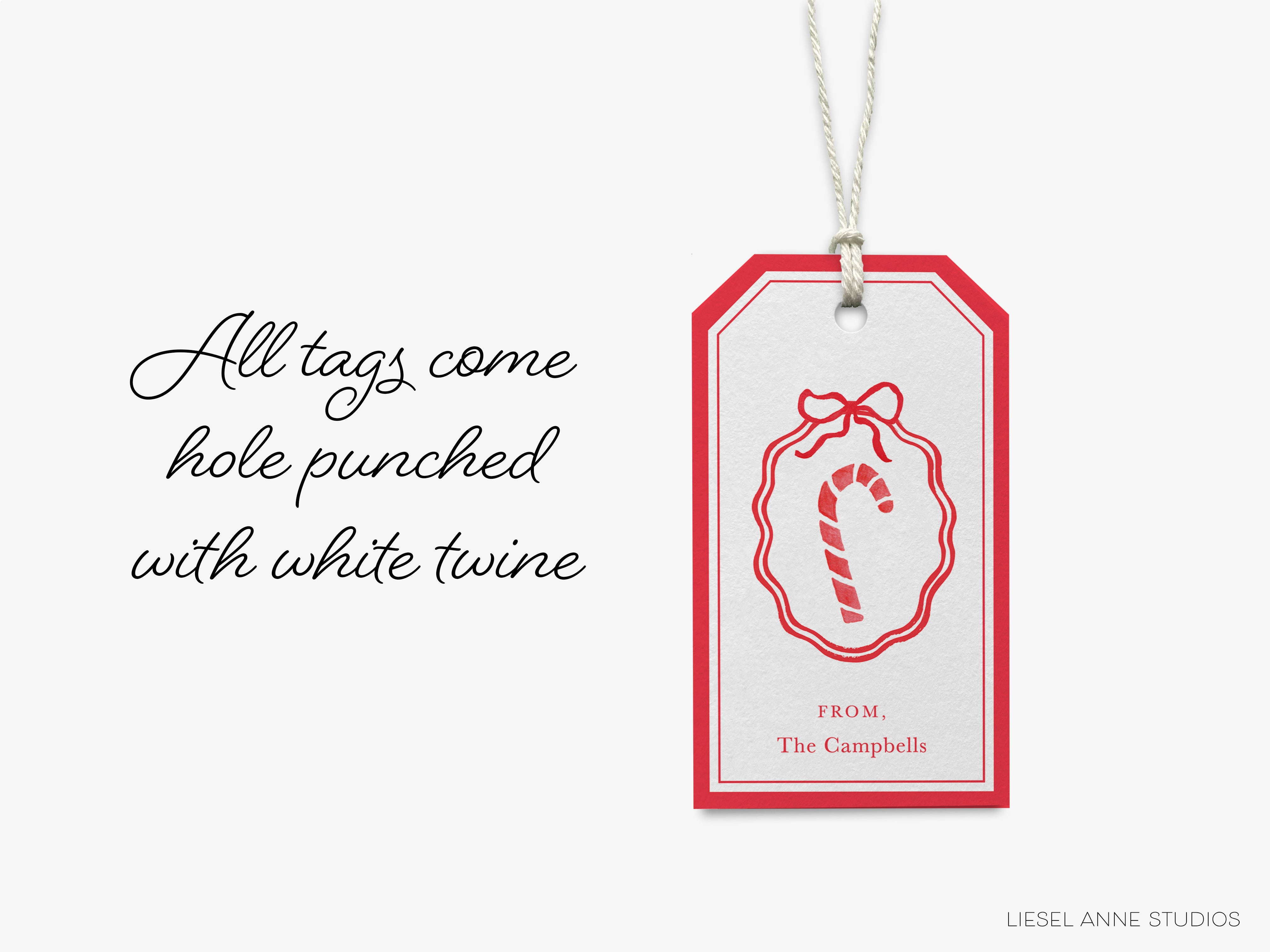 a tag with a red and white design, hanging on a string. The tag has a caption that reads "All tags come hole punched with white twine" and a small illustration of a candy cane.