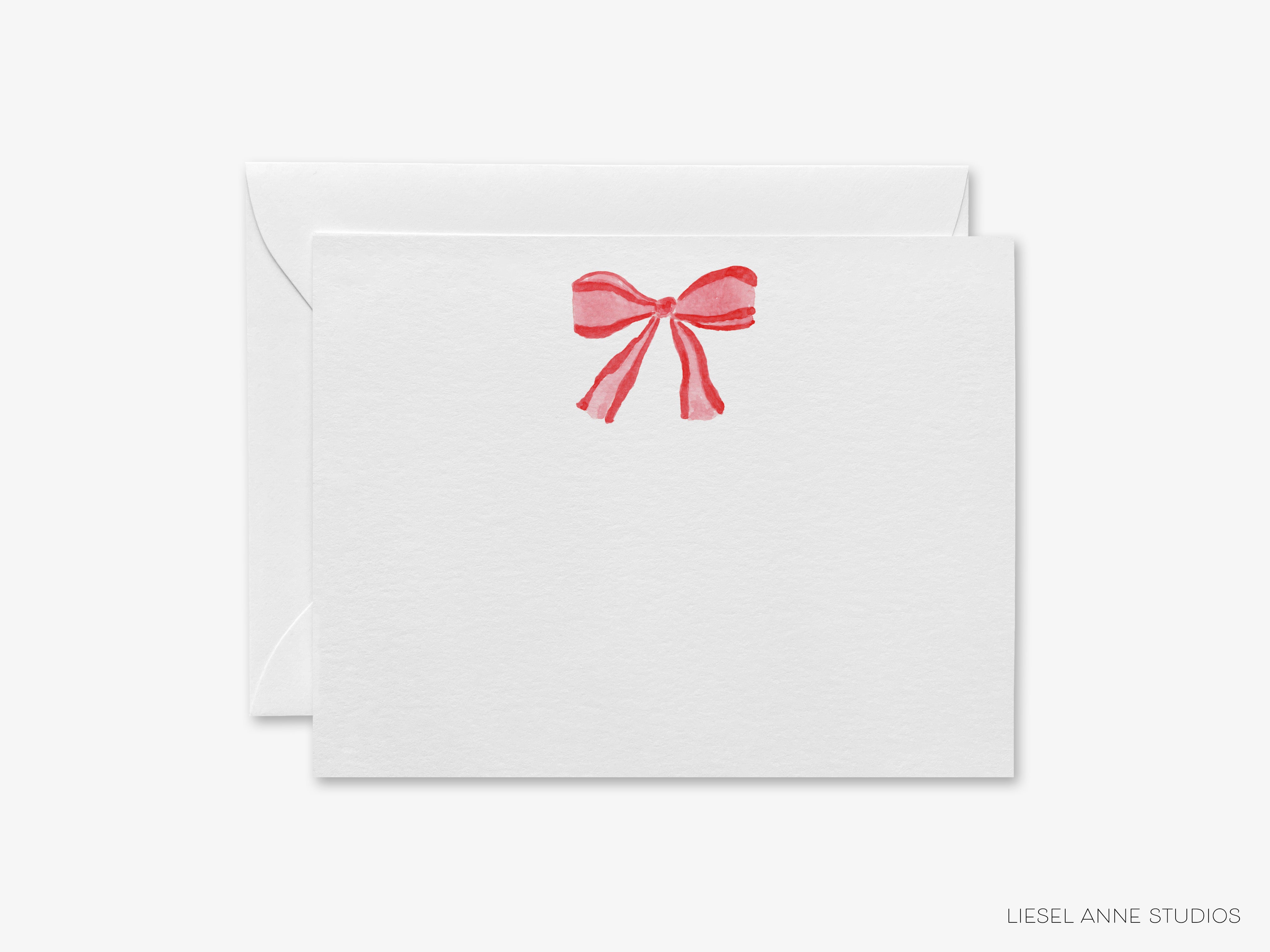 A white envelope with a red bow on it.