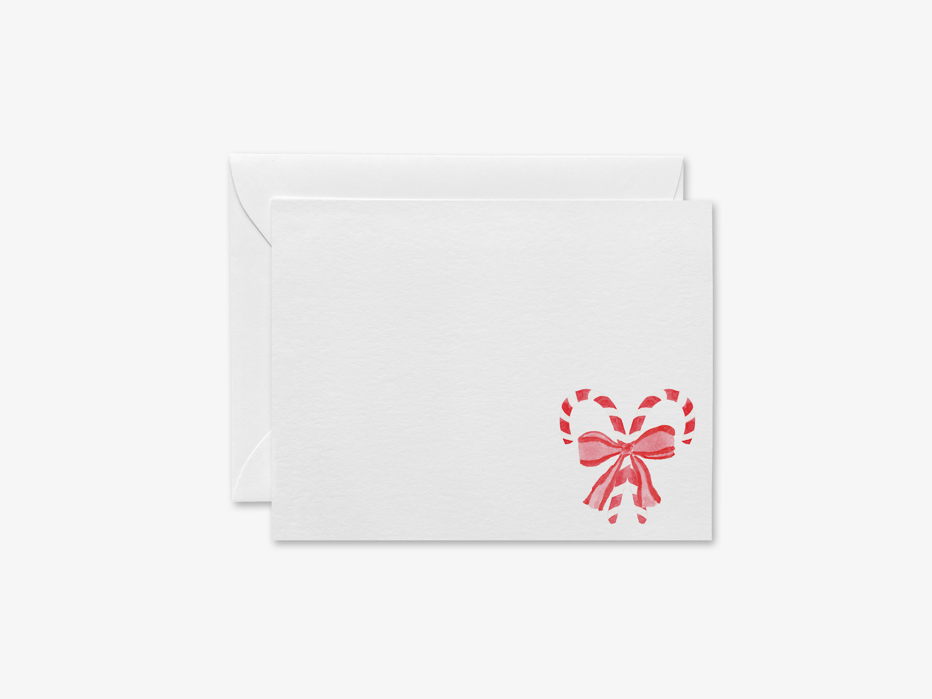 a white envelope with a red heart-shaped candy cane design on the right side.